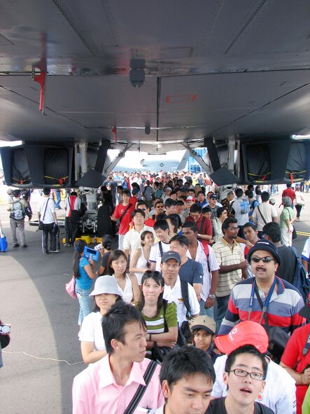 Spectators wait in line to peer inside the cockpit of a B-1B Lancer aircraft Feb. 23 during a public day at the 2008 Singapore Air Show. The United States provided Air Force F-16 Fighting Falcon and Navy F/A-18 Super Hornet demonstations and seven aircraft for static display. (U.S. Air Force photo/Senior Master Sgt. Charles Ramey) 