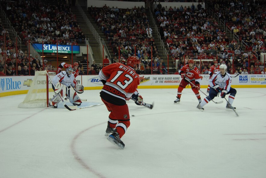 Ray Whitney shoots the puck during Military Appreciation Night at the National Hockey League game between the Carolina Hurricanes and Washington Capitals Feb. 23 in Raleigh, N.C.. Pope received 250 tickets for the event. (U.S. Air Force Photo by 2nd Lt. Chris Hoyler)