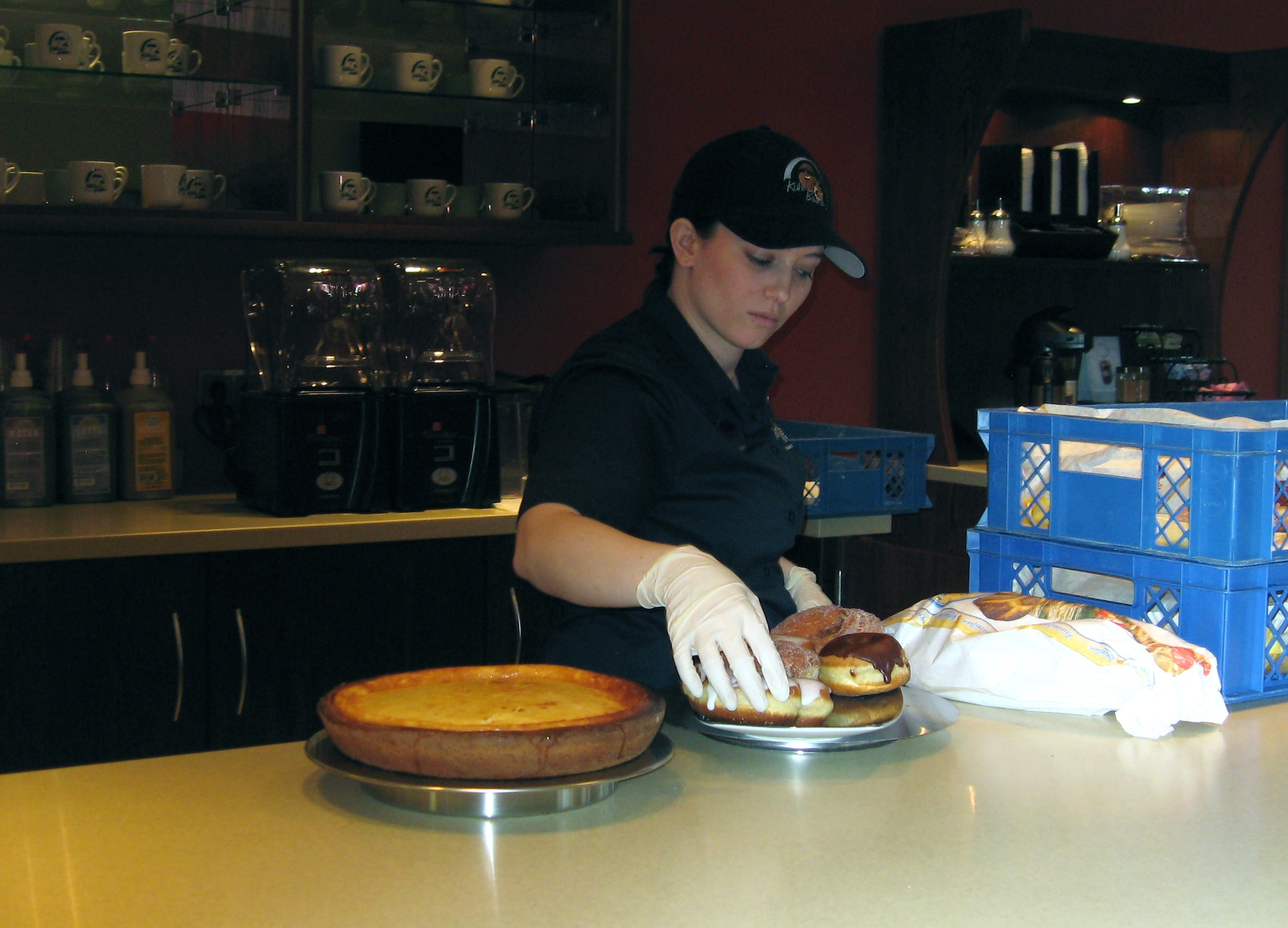 SPANGDAHLEM AIR BASE, Germany – Kayleigh Anderson, Kulh Beanz manger, prepares pastries to be placed on display. Kuhl Beans, located in the Wilkommen Center, officially opens March 4. The hours of operation are scheduled to be Mondays through Fridays from 6 a.m. to 8 p.m. and Saturdays and Sundays from 10 a.m. to 8 p.m. (U.S. Air Force photo/Staff Sgt. Tammie Moore)  