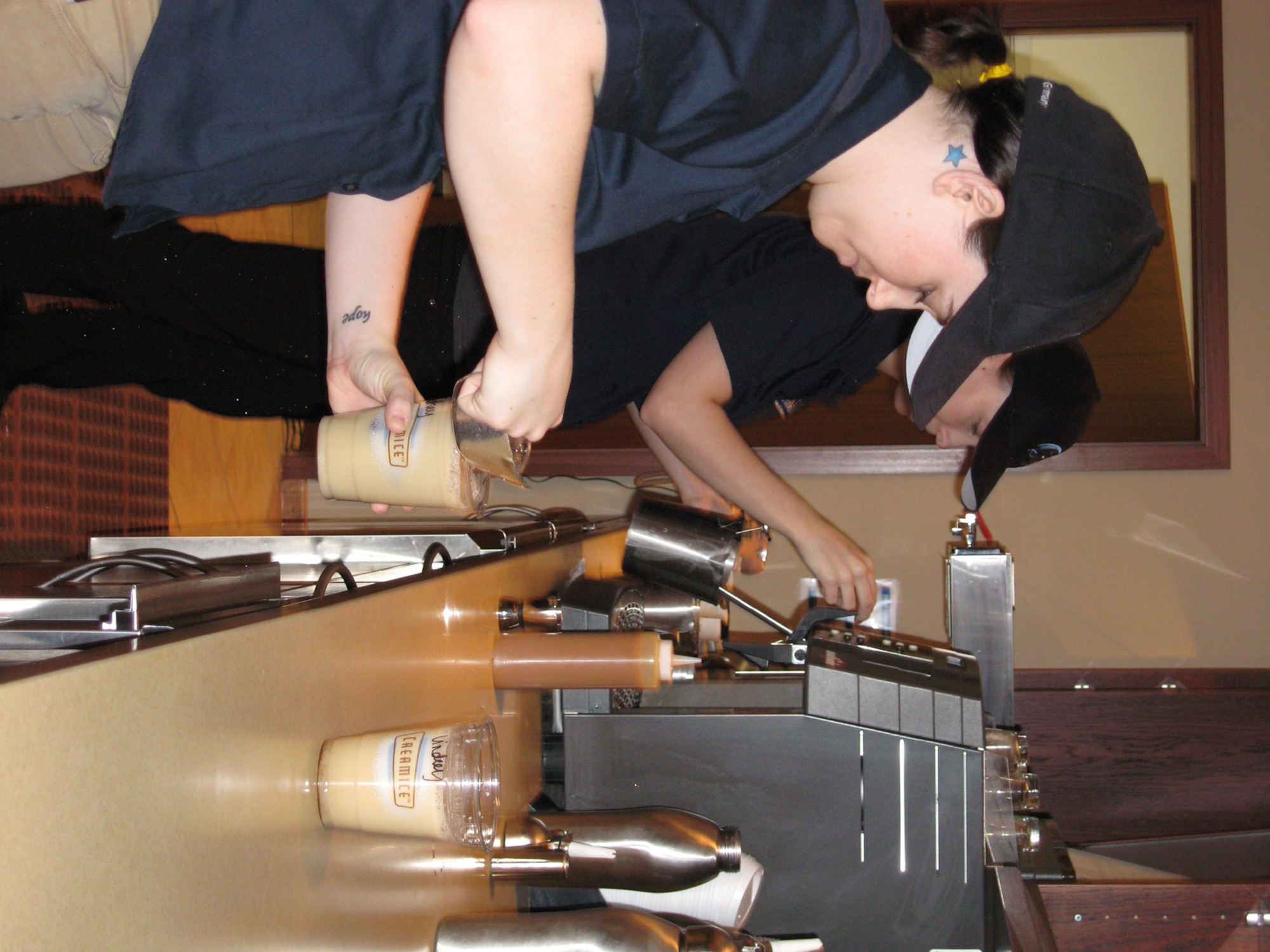 SPANGDAHLEM AIR BASE, Germany – Kayleigh Anderson (front) and Stephanie Kyota, Kulh Beanz employees, fill customer orders. Kuhl Beans, located in the Wilkommen Center, officially opens March 4. The hours of operation are scheduled to be Mondays through Fridays from 6 a.m. to 8 p.m. and Saturdays and Sundays from 10 a.m. to 8 p.m. (U.S. Air Force photo/Staff Sgt. Tammie Moore) 