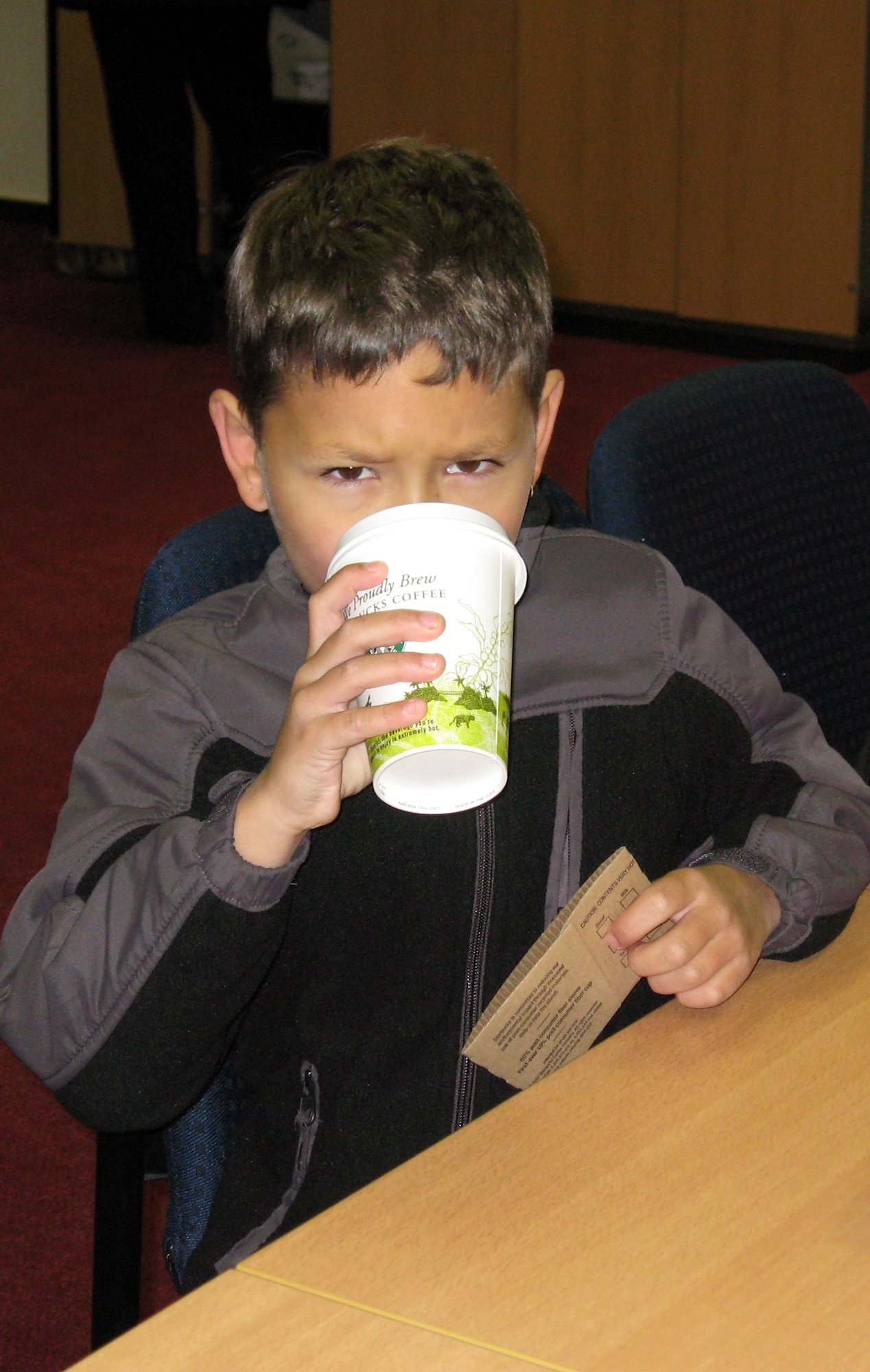 SPANGDAHLEM AIR BASE, Germany – Robert Whittekiend, son of Staff Sgt. Robert Whittekiend, 52nd Aircraft Maintenance Squadron, enjoys a hot chocolate from Kuhl Beans. Kuhl Beans officially opens March 4. (U.S. Air Force photo/Staff Sgt. Tammie Moore) 