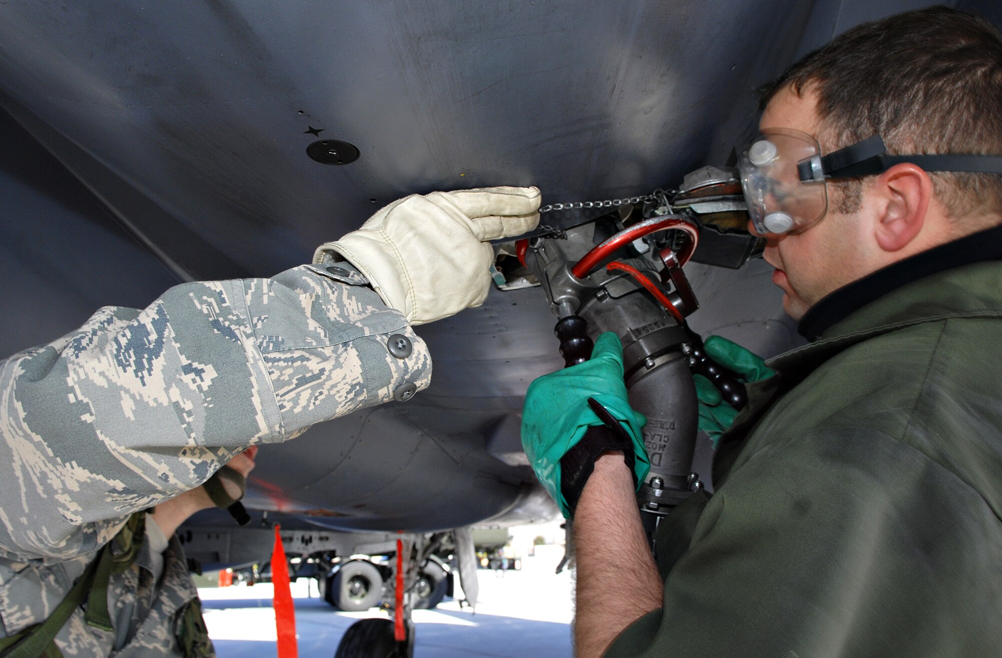 MOUNTAIN HOME AIR FORCE BASE, Idaho – Staff Sgt. Doug Williams, 391st Aircraft Maintenance Unit crew chief, assists Tech. Sgt. Jaime Jones, 366th Logistics Readiness Squadron Petroleum Oil and Lubricants fuels technician, secure a fuel hose to an F-15E Strike Eagle during Exercise Sharpshooter 08-04.1 Feb. 28. Fuel technicians are responsible for refueling the jets after they land in the deployed location, making them mission ready. The 366th Fighter Wing conducts exercises to prepare personnel and equipment for the upcoming March 2008 Operational Readiness Inspection. (U.S. Air Force photo/ Airman 1st Class Ryan Crane) 
