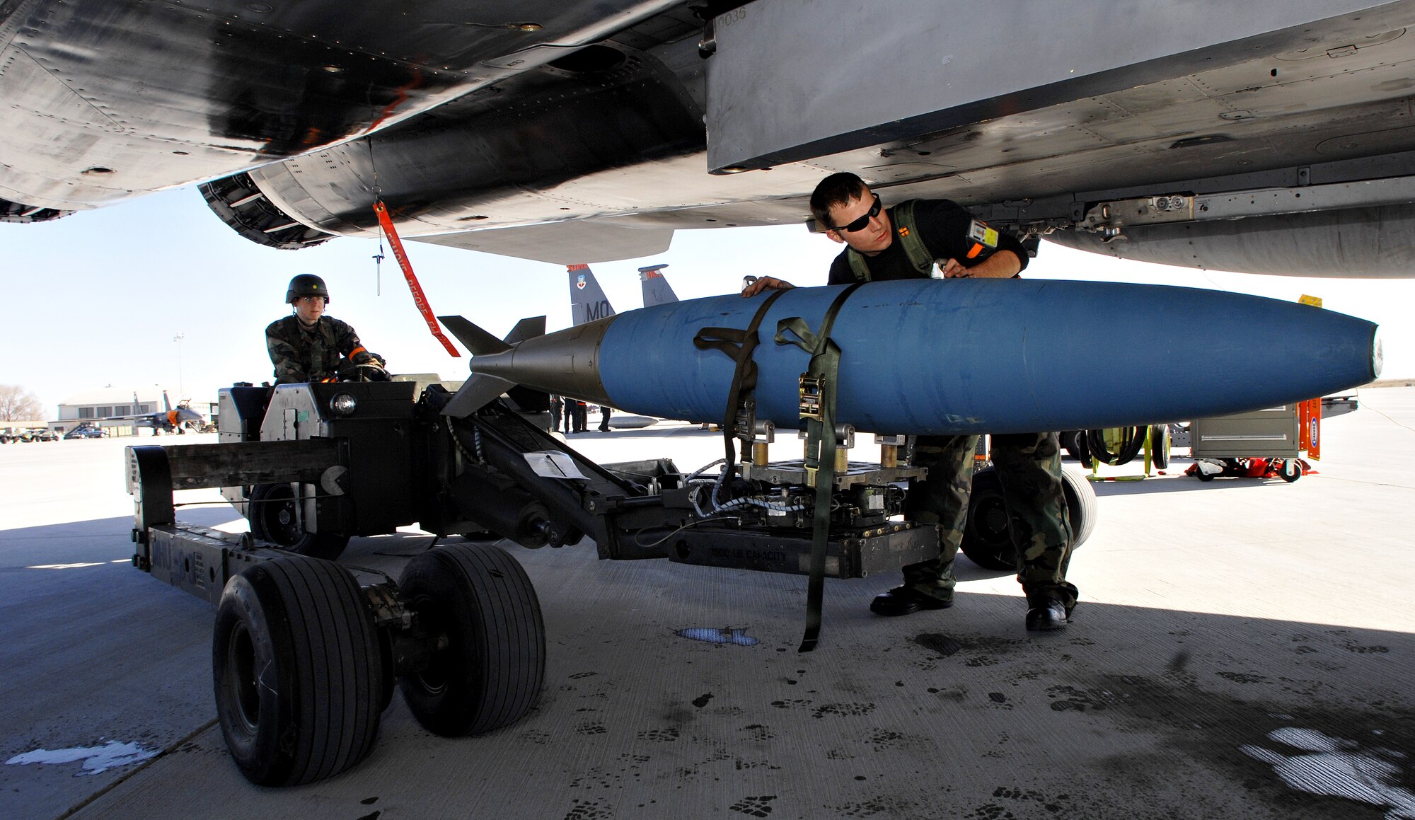 MOUNTAIN HOME AIR FORCE BASE, Idaho – Staff Sgt. Lars Wetli, 391st Aircraft Maintenance Unit weapons load technician, attaches a Mark 84 bomb to an F-15E Strike Eagle with the assistance of his load crew during Exercise Sharpshooter 08-04.1 Feb. 28. Weapons load crews hustle to upload weapons to the jets after their arrival in the simulated deployed location to prepare the jets for their first mission. The 366th Fighter Wing conducts exercises to prepare personnel and equipment for the upcoming March 2008 Operational Readiness Inspection. (U.S. Air Force photo/ Airman 1st Class Ryan Crane) 