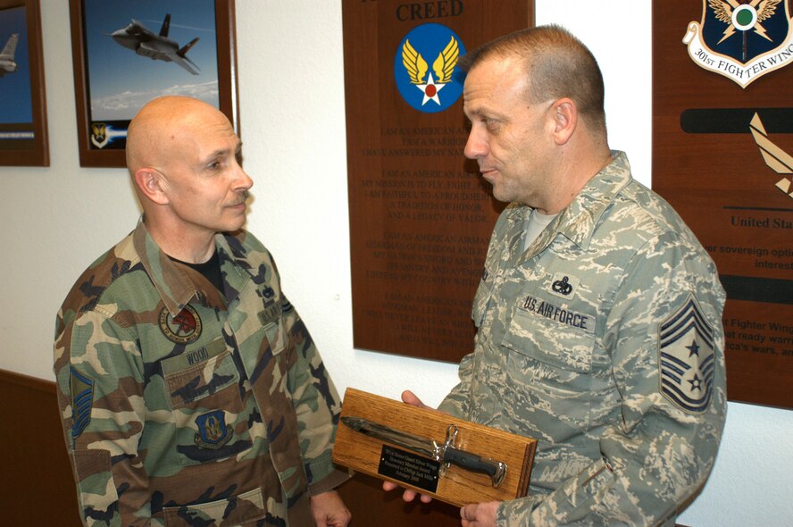 This year's Chief Master Sgt. Stephen Adams "Silver Wings" Honorary Honor Guard member recipient was presented to Chief Master Sgt. Jack Mills, 301st Fighter Wing's Command Chief Master Sgt. by Master Sgt. Ross Wood, 301st Honor Guard superintendent. Each recipient receives a mounted chromed Honor Guard bayonet with an engraved name plate. Past winners have included Brig. Gen. Neil Rohan, former 301st FW commander, and Chief Master Sgt. Bradley Scott, former 301st FW CCMS. (U.S. Air Force Photo/Tech. Sgt. Stephen Bailey)
                                