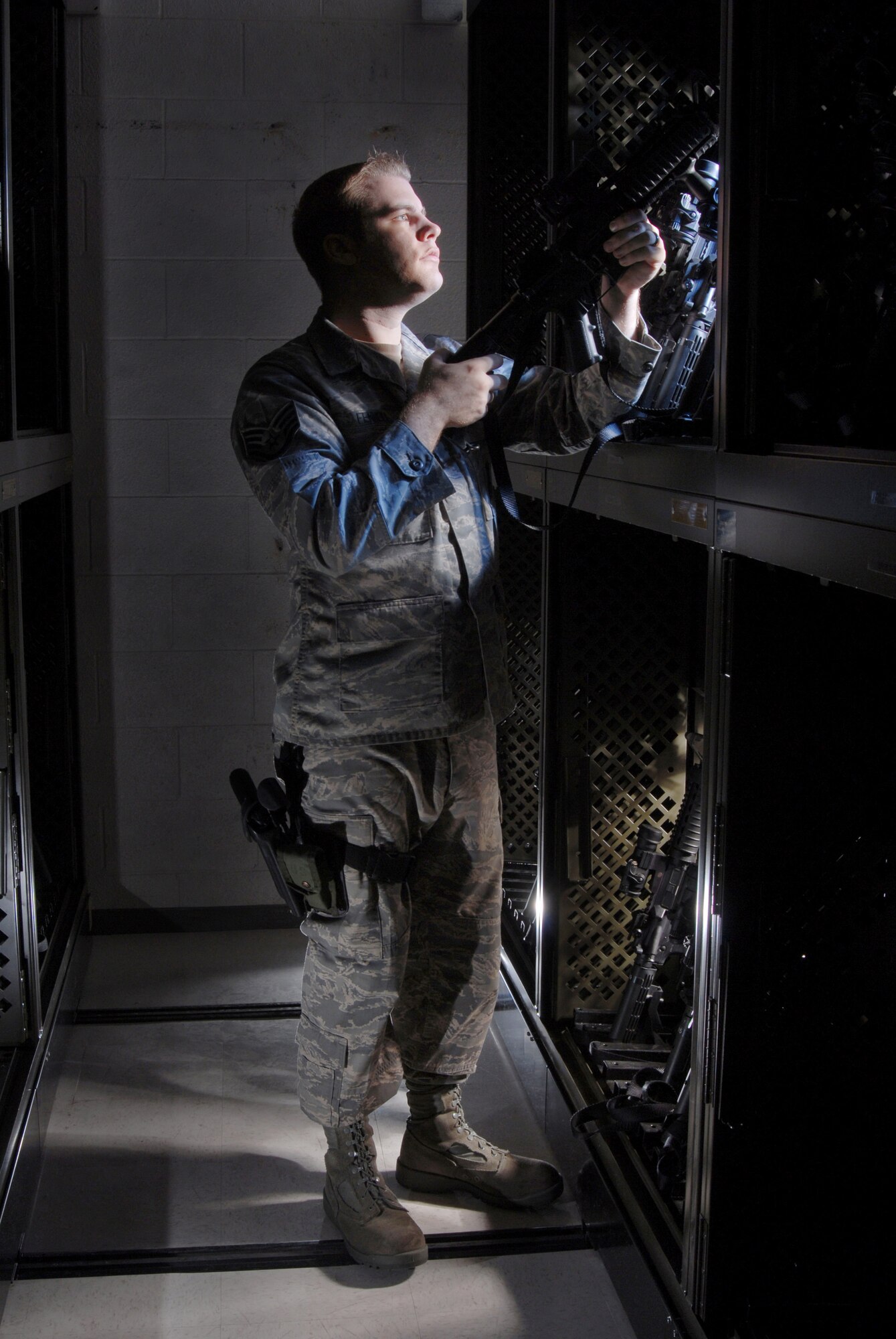 Staff Sgt. Andrew Fennell visually inspects the M-68 scope on a 5.56 mm M-4 carbine rifle at the armory at March Air Reserve Base, Calif., on Feb. 28. The 452nd SFS provides force protection programs to include weapon system security, police services, resource protection and antiterrorism for the 452nd Air Mobility Wing at March ARB. They also maintain a wartime and contingency rapid deployment capability to conduct force protection operations worldwide. Sergeant Fennell is an armorer from the 452nd Security Forces Squadron. (U.S. Air Force photo/Val Gempis) 
