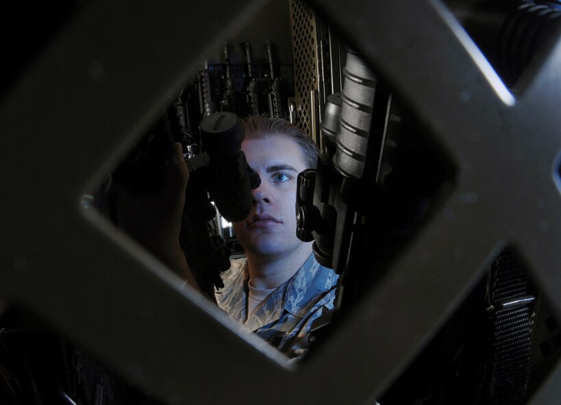 Staff Sgt. Andrew Fennell visually inspects the M-68 scope on a 5.56 mm M-4 carbine rifle at the armory at March Air Reserve Base, Calif., on Feb. 28. The 452nd SFS provides force protection programs to include weapon system security, police services, resource protection and antiterrorism for the 452nd Air Mobility Wing at March ARB. They also maintain a wartime and contingency rapid deployment capability to conduct force protection operations worldwide. Sergeant Fennell is an armorer from the 452nd Security Forces Squadron. (U.S. Air Force photo/Val Gempis) 