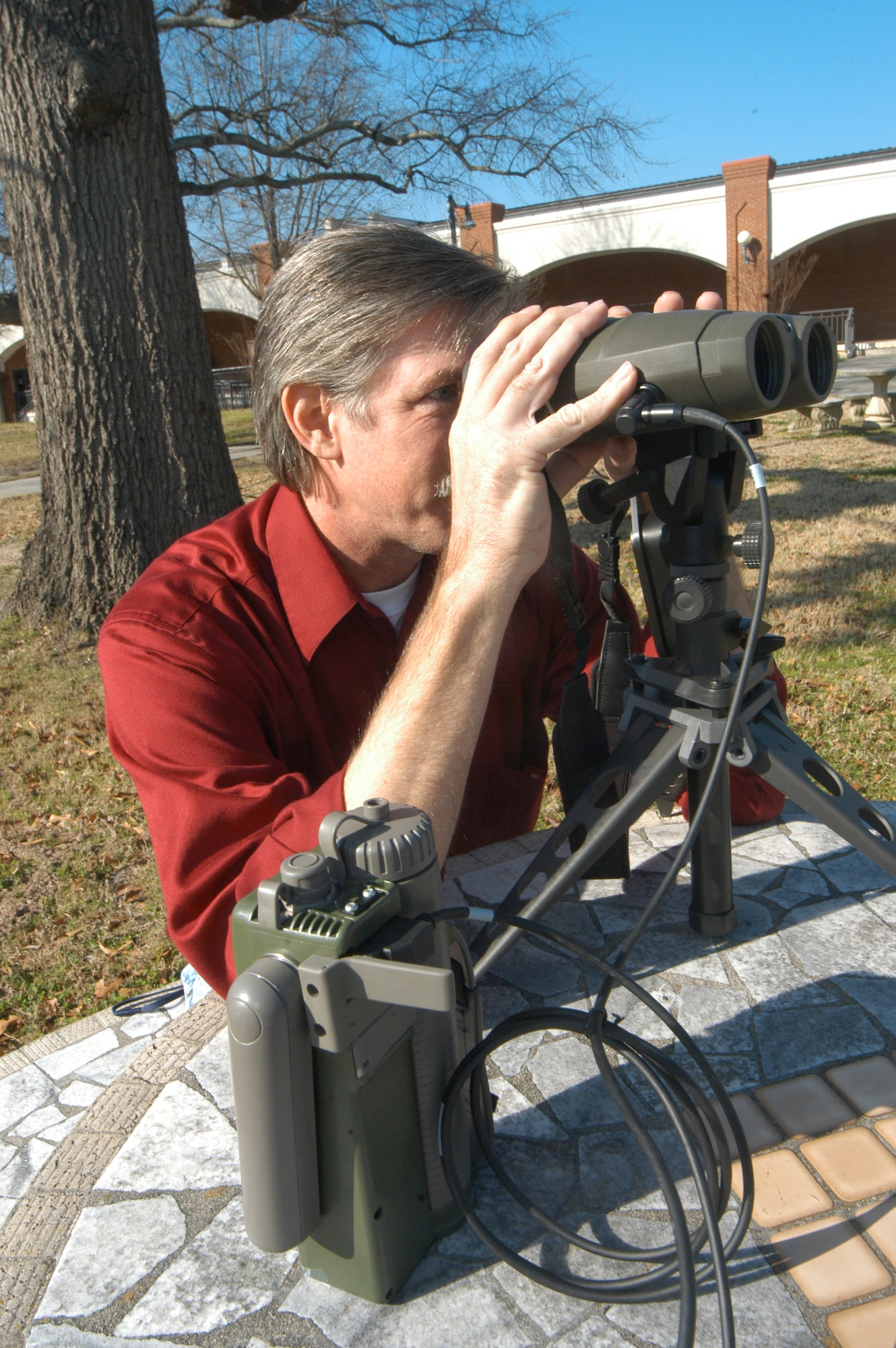 Stephen Morrissey, equipment specialist, demonstrates a Percision Lightweight GPS receiver.   U. S. Air Force photo by Sue Sapp    