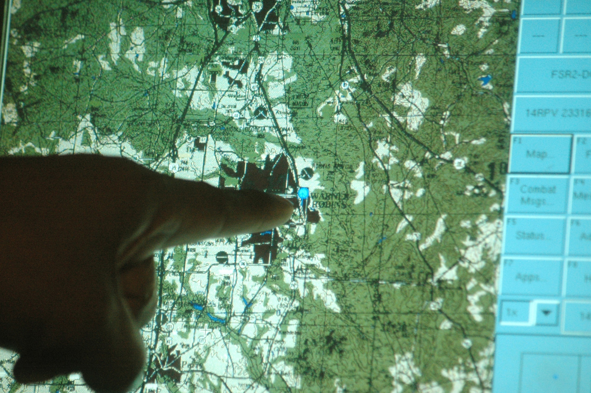 Willie Jackson, integration engineer, shows the  units presently located at Robins. Friendly units are indicated by a blue dot. U. S. Air Force photo by Sue Sapp  