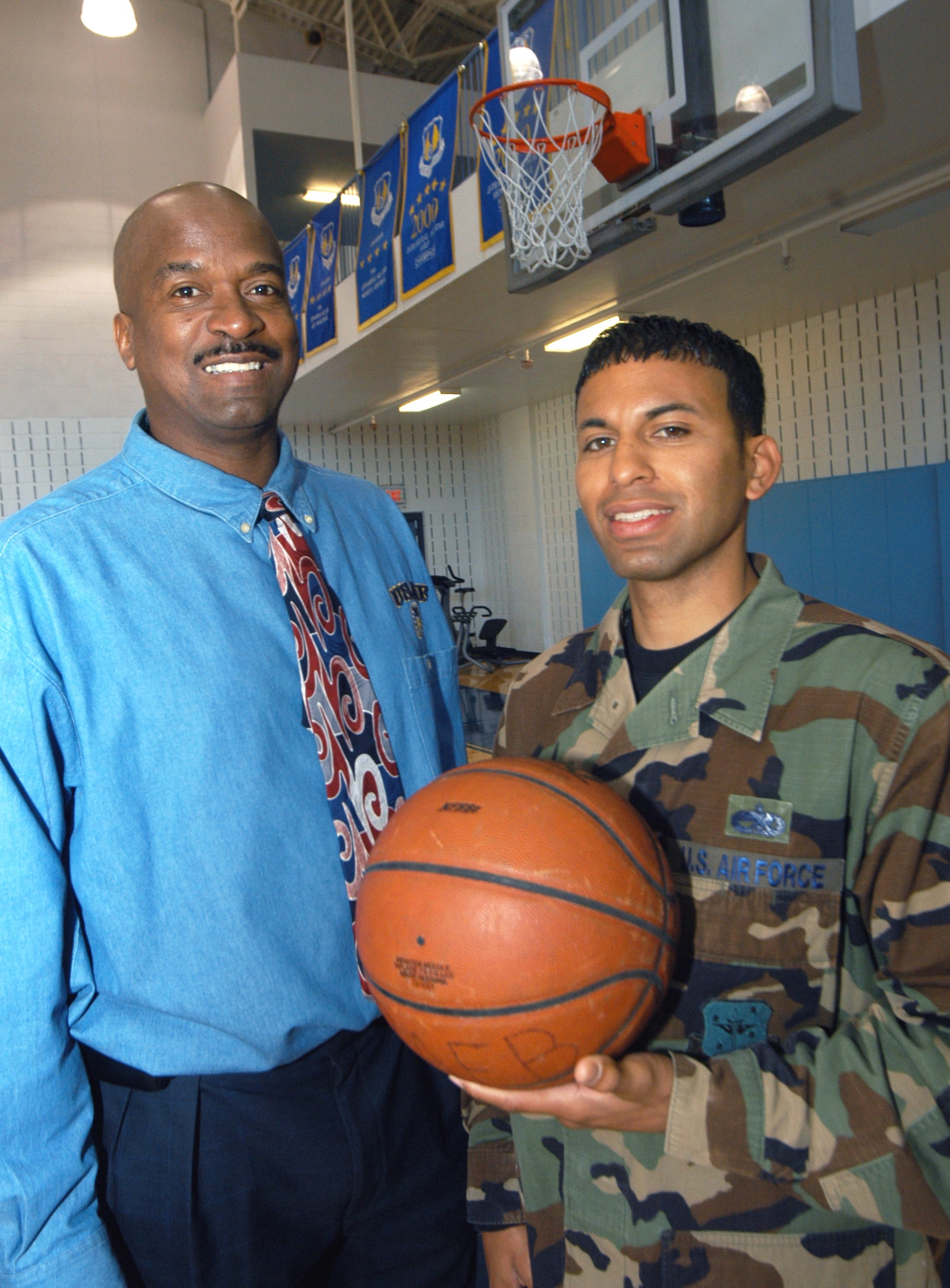 John Bailey (left) an item manager for the  C-17 Product Directorate will coach the Air Force men's basketball team for the third straight season. Staff Sgt. Juan Vasquez, crew chief in the 19th Air Refueling Squadron, is one of 26 players competing for a spot on the team. U. S. Air Force photo by Sue Sapp   
