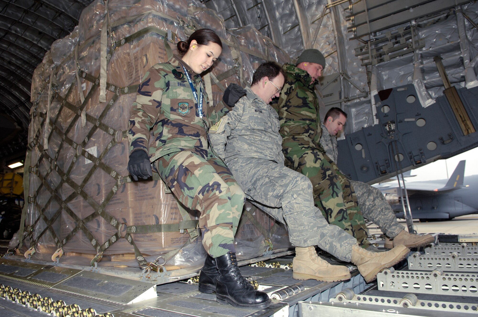 Members of the 305th Aerial Port Squadron move pallets of equipment and supplies for Joint Task Force Operation Burnt Frost onto a C-17 Globemaster III Feb. 20 at McGuire Air Force Base, N.J. The JTF was the recovery part of Operation Burnt Frost which covers the shoot down of the errant satellite loaded with hydrazine. The supplies were for 15 federal agencies tasked to handle the environmental effects of the satellite's reentry into the atmosphere. (U.S. Air Force photo/Kenn Mann) 
