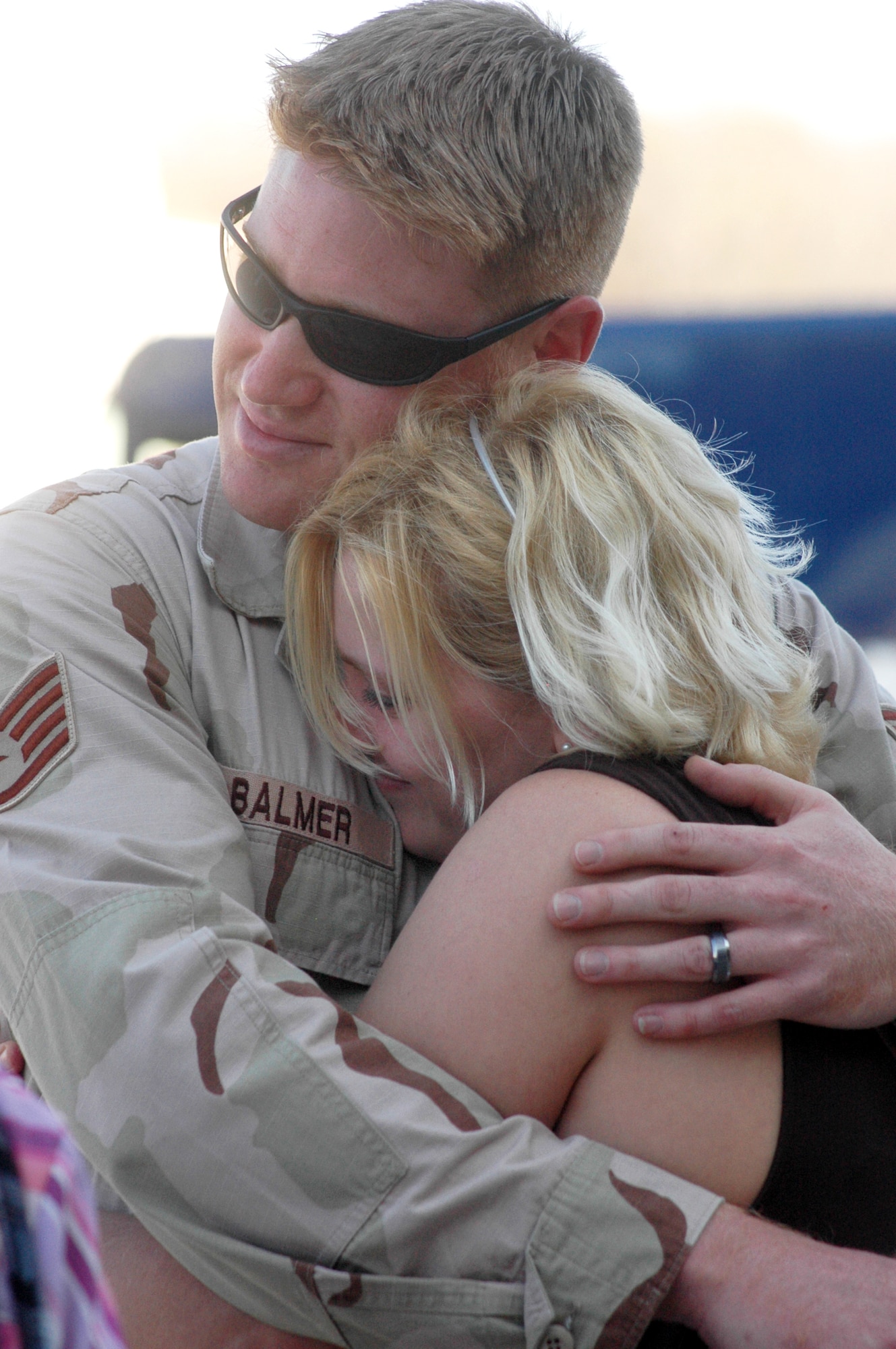 SSgt. Adam Balmer hugs his wife Deidra after returning Feb. 25.  Eleven Airmen from the 19th Air Refueling Group Black Knights, who were deployed, returned from the unit’s last deployment tasking. U. S. Air Force photo by Sue Sapp 
