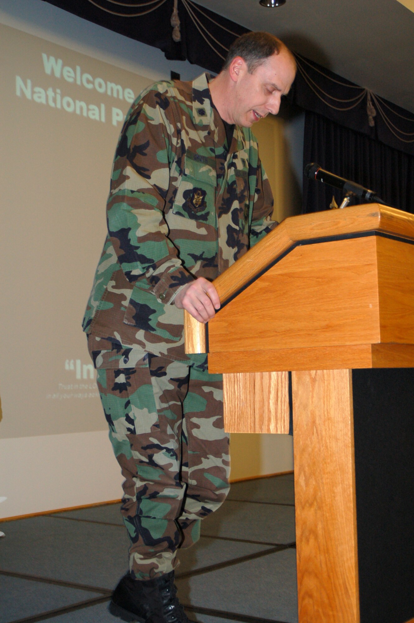 512th Airlift Wing Chaplain (Lt. Col.) John Groth bows his head in prayer at the National Prayer Luncheon Feb. 26 at Dover Air Force Base, Del. The luncheon was attended by more than 200 active duty, Reserve, DoD employees and civilian guests, and it brought together people to recognize the moral and spiritual values upon which the nation was founded. (U.S. Air Force photo/Master Sgt. Melissa Phillips)