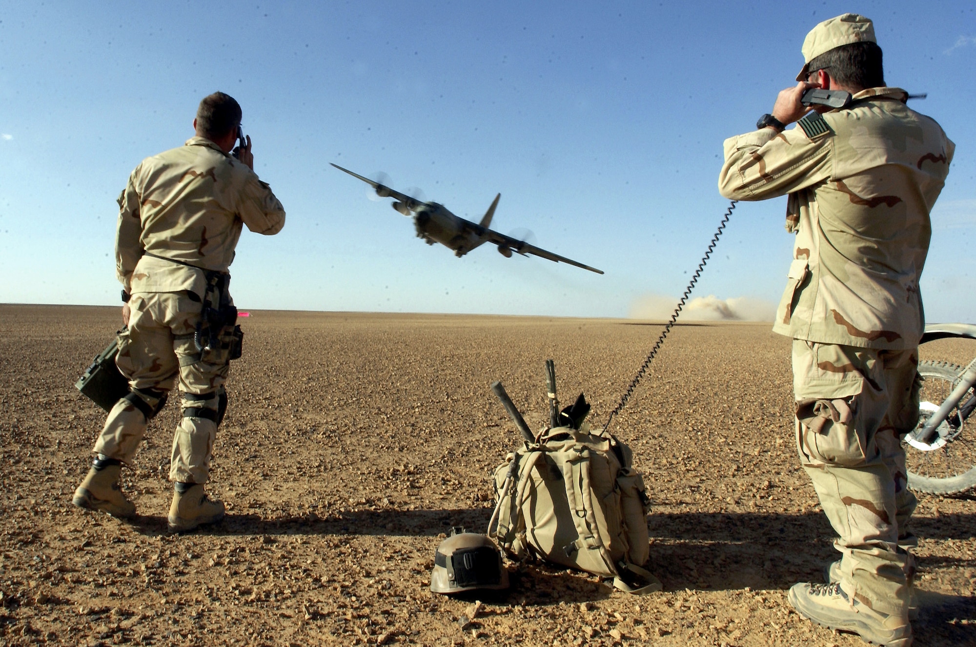 After establishing a runway and clearing airspace, combat controllers (CCT) give a C-130 take off clearance and provide air traffic control while during a mission to establish and assess an airfield March 15, 2003 at an undisclosed location in support of Operation Enduring Freedom.  Air Force combat controllers are organized, trained, and equipped to conduct clandestine, covert, or low visibility operations. These teams establish and control air assault zones, conduct limited offensive, direct action and special reconnaissance operations and assist in the insertion and extraction of Special Operations Forces. (U.S. Air Force photo by Staff Sgt. Jeremy T. Lock) (Released)
