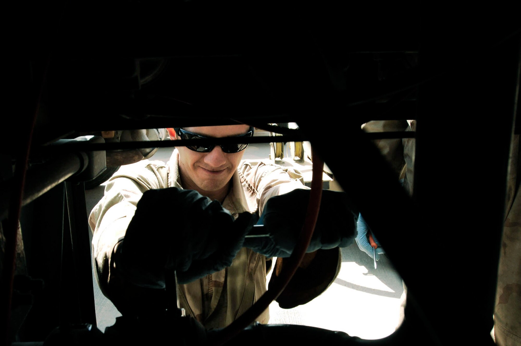 Senior Airman Brandon Huelsman wrenches loose a bolt in the over-wing valve of an R-11 fuel truck for repair Feb. 26 in Southwest Asia. The fuels management flight is responsible for inventorying the fuel daily, and the transfer and issue of fuel to both vehicle operators and aircrews in support of operations Enduring Freedom and Iraqi Freedom. Airman Huelsman is a refueling maintenance technician from the 386th Expeditionary Logistics Readiness Squadron. (U.S. Air Force photo/ Staff Sgt. Patrick Dixon) 