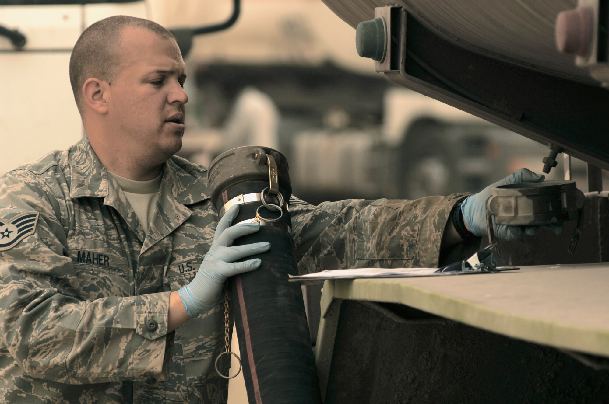 Staff Sgt. Kenneth Maher examines a fuel hose before downloading fuel from a truck into a bladder storage unit Feb. 26 in Southwest Asia. The fuels management flight is responsible for inventorying the fuel daily, and the transfer and issue of fuel to both vehicle operators and aircrews in support of operations Enduring Freedom and Iraqi Freedom. Sergeant Maher is a fuels technician from the 386th Expeditionary Logistics Readiness Squadron. (U.S. Air Force photo/Staff Sgt. Patrick Dixon) 
