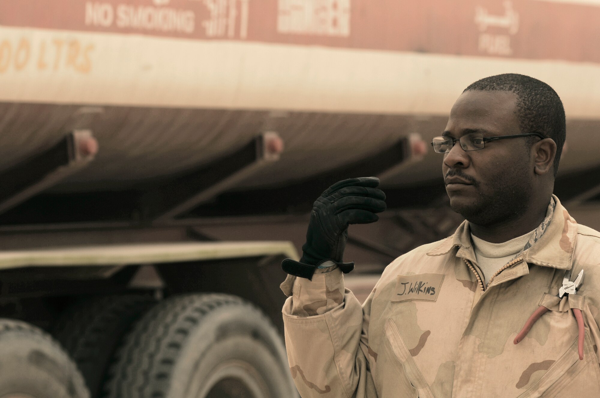 Staff Sgt. Jerome Wilkins motions forward another fuel truck to have its fuel downloaded into a bladder storage unit Feb. 26 in Southwest Asia. The fuels management flight is responsible for inventorying the fuel daily, and the transfer and issue of fuel to both vehicle operators and aircrews in support of operations Enduring Freedom and Iraqi Freedom. Sergeant Wilkins is a fuels technician from the 386th Expeditionary Logistics Readiness Squadron. (U.S. Air Force photo/Staff Sgt. Patrick Dixon) 