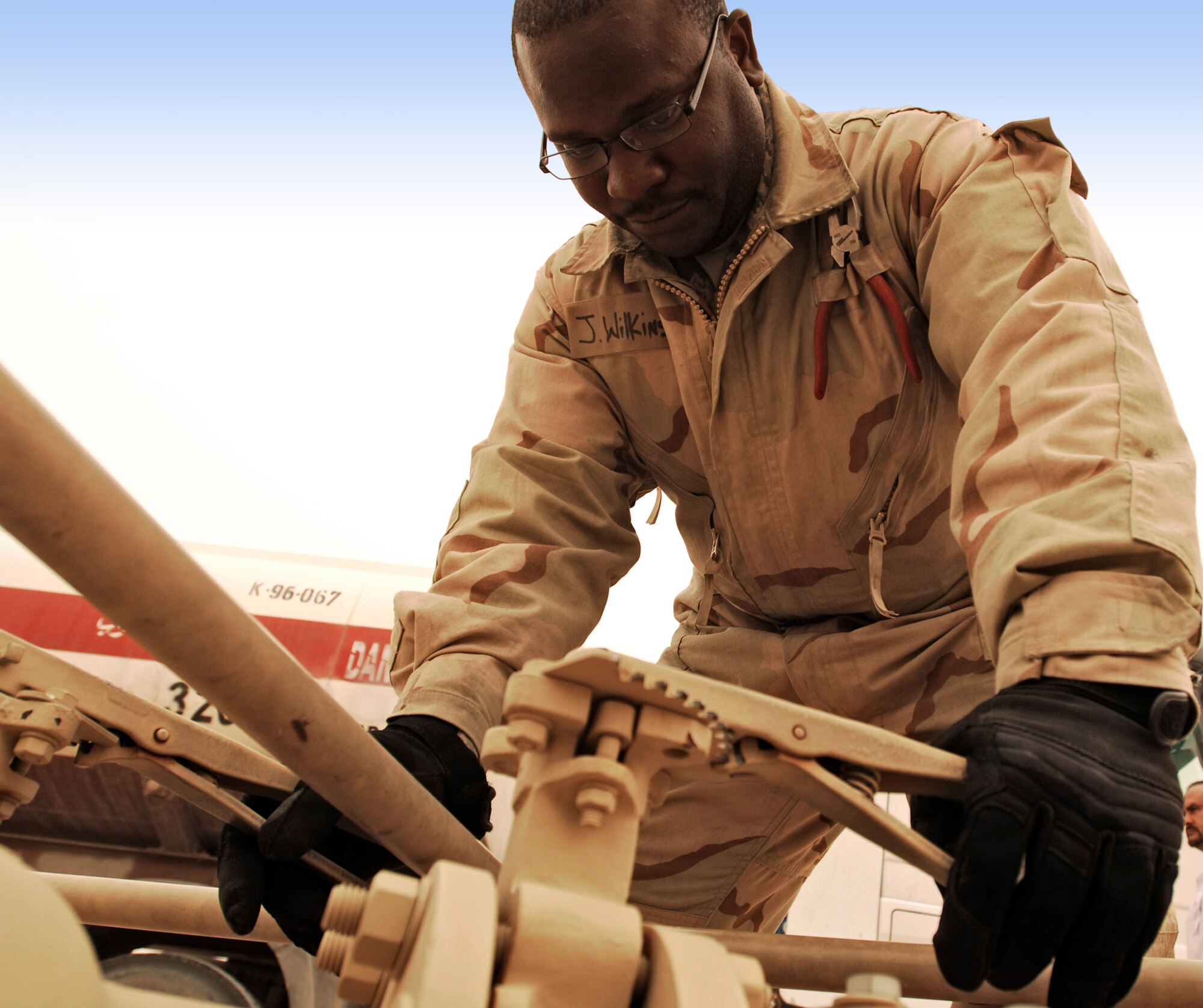 Staff Sgt. Jerome Wilkins watches the sight glass on a receipt wye skid valve to ensure the flow stays constant during the fuel download from trucks into a bladder storage unit Feb. 26 in Southwest Asia. The fuels management flight is responsible for inventorying the fuel daily, and the transfer and issue of fuel to both vehicle operators and aircrews in support of operations Enduring Freedom and Iraqi Freedom. Sergeant Wilkins is a fuels technician from the 386th Expeditionary Logistics Readiness Squadron. (U.S. Air Force photo/Staff Sgt. Patrick Dixon) 