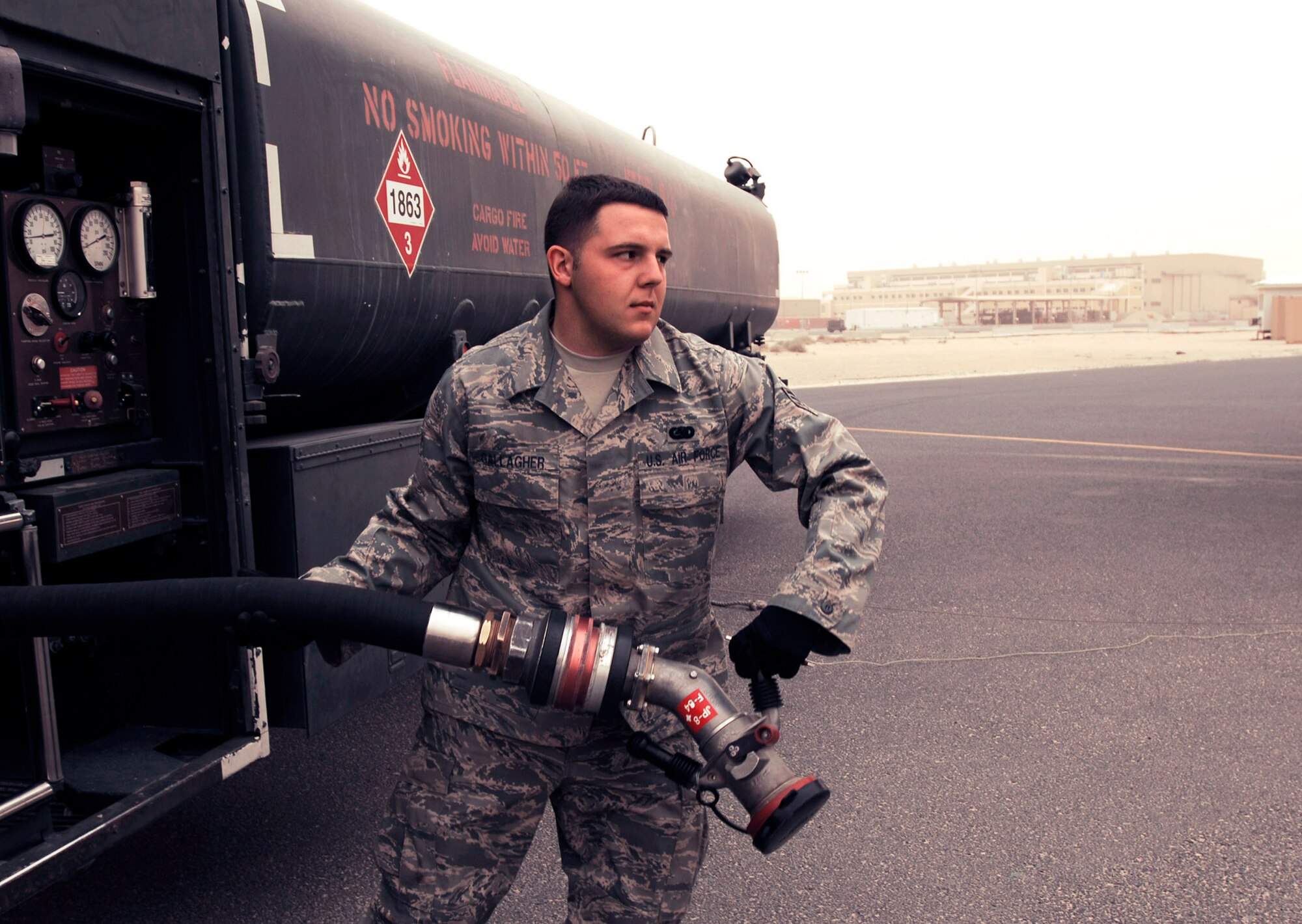 Senior Airman Bryan Gallagher pulls a three-inch hose off an R-11 fuel truck toward a C-130 Hercules needing to be refueled Feb. 26 in Southwest Asia. The fuels management flight is responsible for inventorying the fuel daily, and the transfer and issue of fuel to both vehicle operators and aircrews in support of operations Enduring Freedom and Iraqi Freedom. Airman Gallagher is a fuels technician from the 386th Expeditionary Logistics Readiness Squadron. (U.S. Air Force photo/Staff Sgt. Patrick Dixon