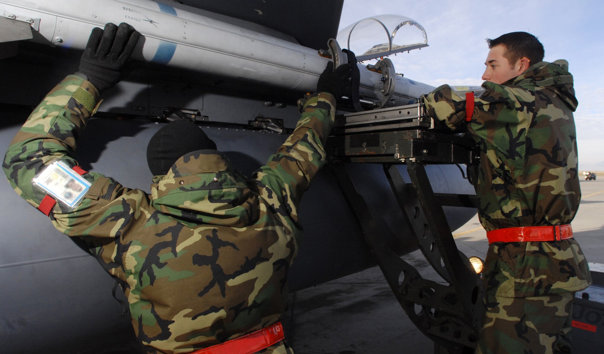 MOUNTAIN HOME AIR FORCE BASE, Idaho - Staff Sgt. Wesley Daniel (left) and Airman 1st Class Marshall Meyer, 389th Aircraft Maintenance Unit weapons load crew members, load an AIM-120 missile onto an F-15E Strike Eagle during Exercise Sharpshooter 08-04.1 Feb. 27. Maintenance crews are working throughout the Phase I to prepare deploying jets to leave for the simulated deployed location.  The 366th Fighter Wing conducts exercises to prepare personnel and equipment for the upcoming March 2008 Operational Readiness Inspection. (U.S. Air Force photo/ Airman 1st Class Ryan Crane)