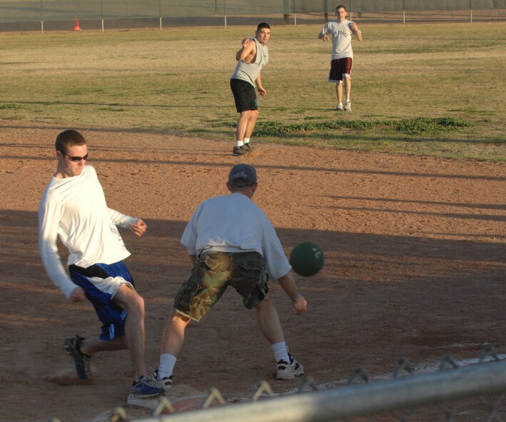 Aaron Youngblood, 56th Medical Group, is safe, making it to the base just before Robert Zoellner, 56th Fighter Wing Public Affairs, catches the ball. The kickball tournament began Feb. 19 and the championship game between Public Affairs and 56th Aircraft Maintenance Squadron was Feb. 21. AMXS won 10-6. (photo by Tech. Sgt. Raheem Moore)