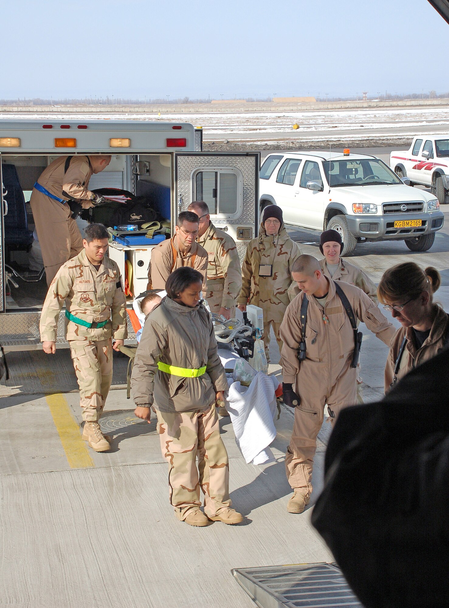 A medical team evacuates Airman 1st Class James Garrett Feb. 26 at Manas Air Base, Kyrgyzstan. Airman Garrett, deployed from Shaw Air Force Base, S.C., is part of the 376th Expeditionary Civil Engineer Squadron firefighter's dodgeball team, which was facing off against the 376th Air Expeditionary Wing Staff team Feb. 25 when he collapsed. Players from both teams pulled together to assist him once they realized what had happened. Airman Garrett is a 376th ECES fire protection journeyman. (U.S. Air Force photo/Tech. Sgt. Jerome Baysmore)