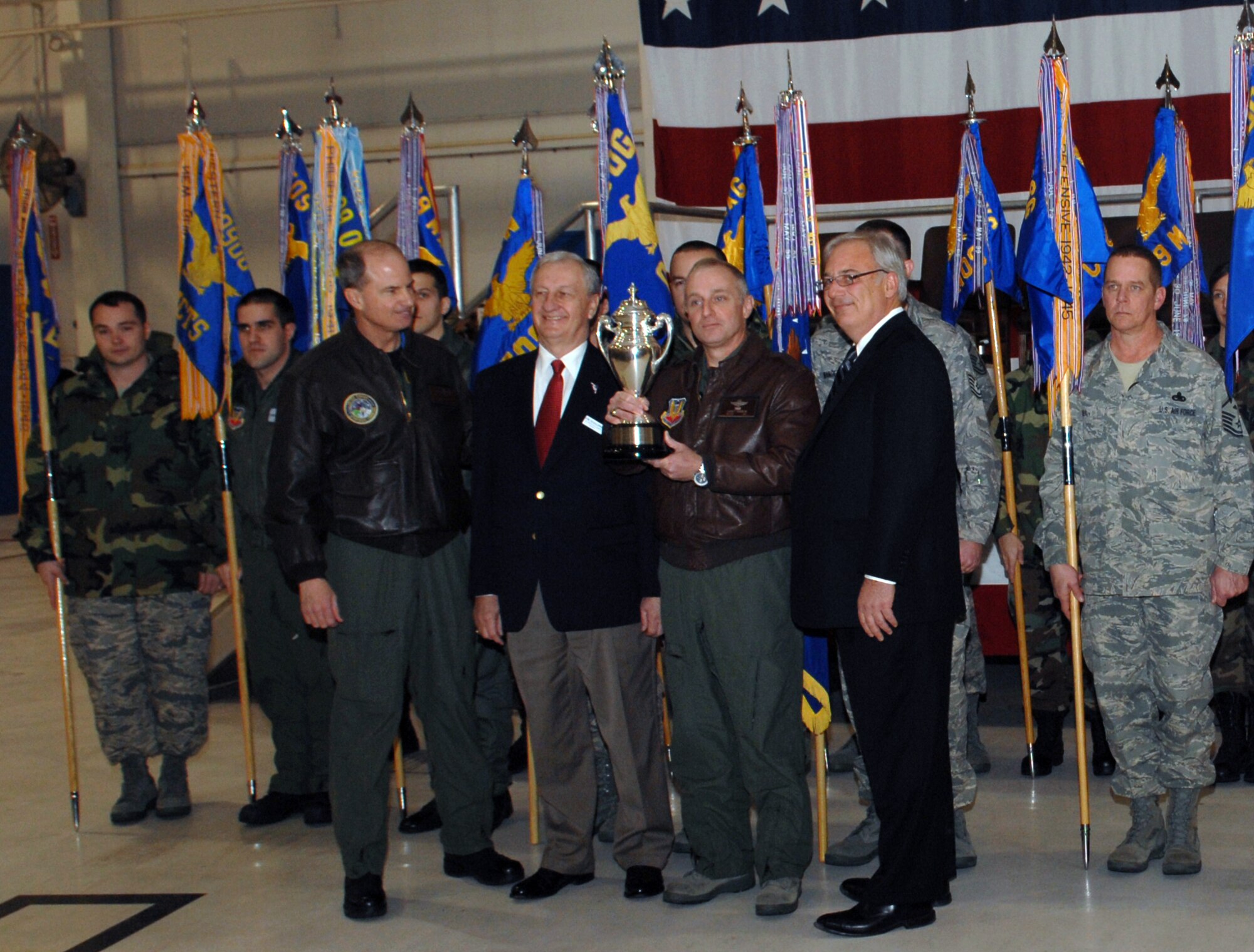 WHITEMAN AIR FORCE BASE, Mo. - Joe Scallorns, Base Community Council member and Brig. Gen. Gary Harencak, 509th Bomb Wing commander (middle left to middle right respectively), display the Omaha Trophy presented by Gen. Kevin Chilton, U.S. Strategic Command commander, Offutt Air Force Base, Neb., and Jim Krieger, Gallup Poll organization vice president (far left and far right respectively). The Omaha Trophy was presented to the Strategic Air Command in 1971 on behalf of the citizens of Omaha, Neb., by the SAC Consultation Committee, with the request that it be awarded annually to the outstanding SAC wing. 