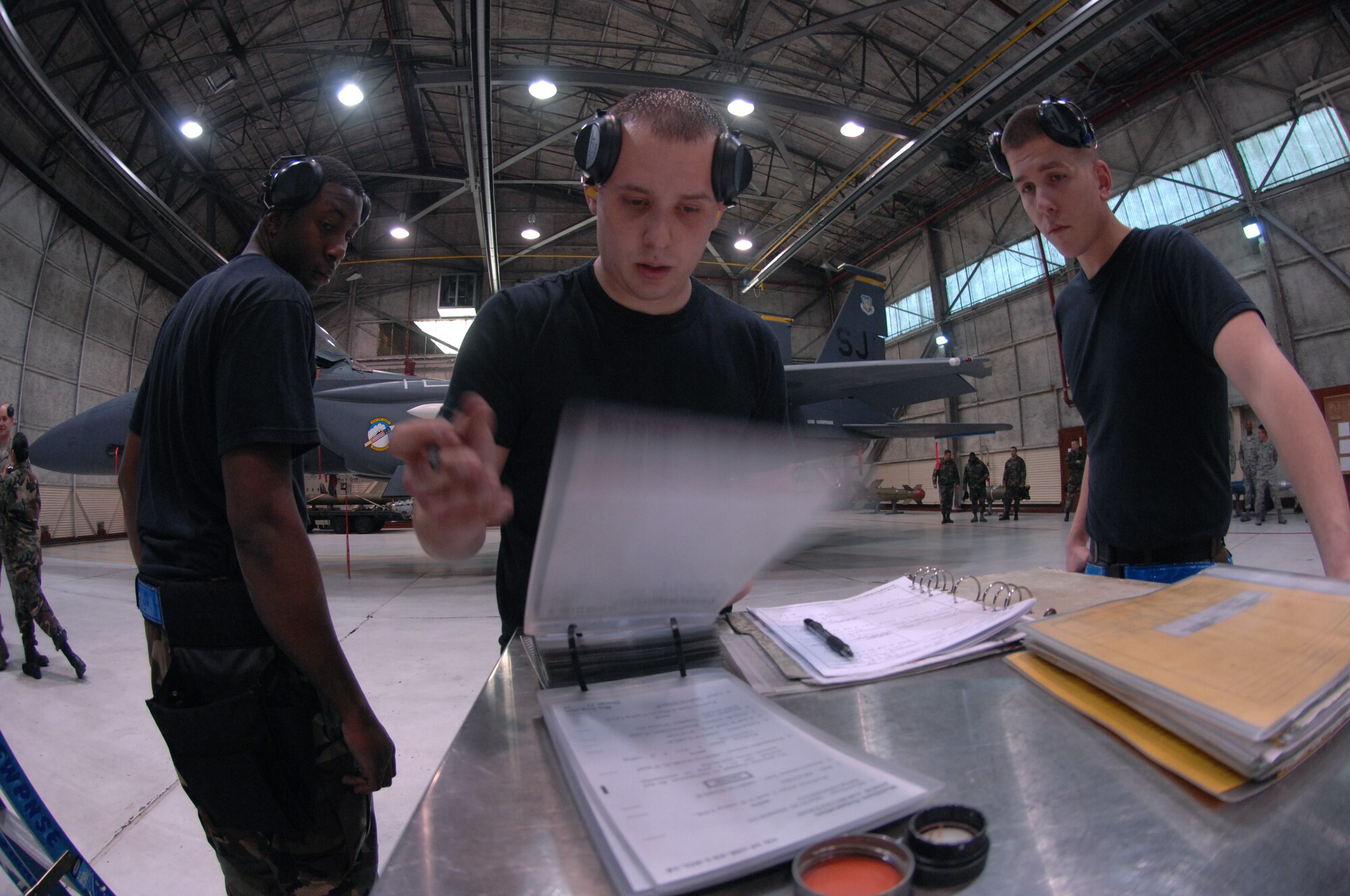 Staff Sergeants Jimmie Stroud, Matthew Simpson, and Airman First Class Cody Jurgensmeyer, 334th Aircraft Maintenance Unit, go through a check list to ensure all tasks are completed.  The Airman are apart of a Weapons Load Competition at Seymour Johnson AFB, North Carolina, February 27, 2008.

(US Air Force Photo by Airman First Class Salma Din)(Released)
