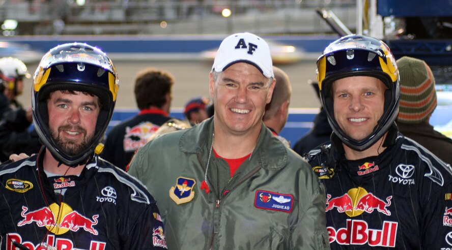 FONTANA, Calif. – Lt. Col. Jon Counsell, 87th Flying Training Squadron “Red Bulls,” meets with members of the Red Bull Racing Team pit crew at a race Feb. 24.  Colonel Counsell was the lead pilot in a four-ship formation of T-38 Talon jets that flew over California Speedway to start the 2008 NASCAR California Sprint Cup.  (Contributed photo by Matt Amboziak)