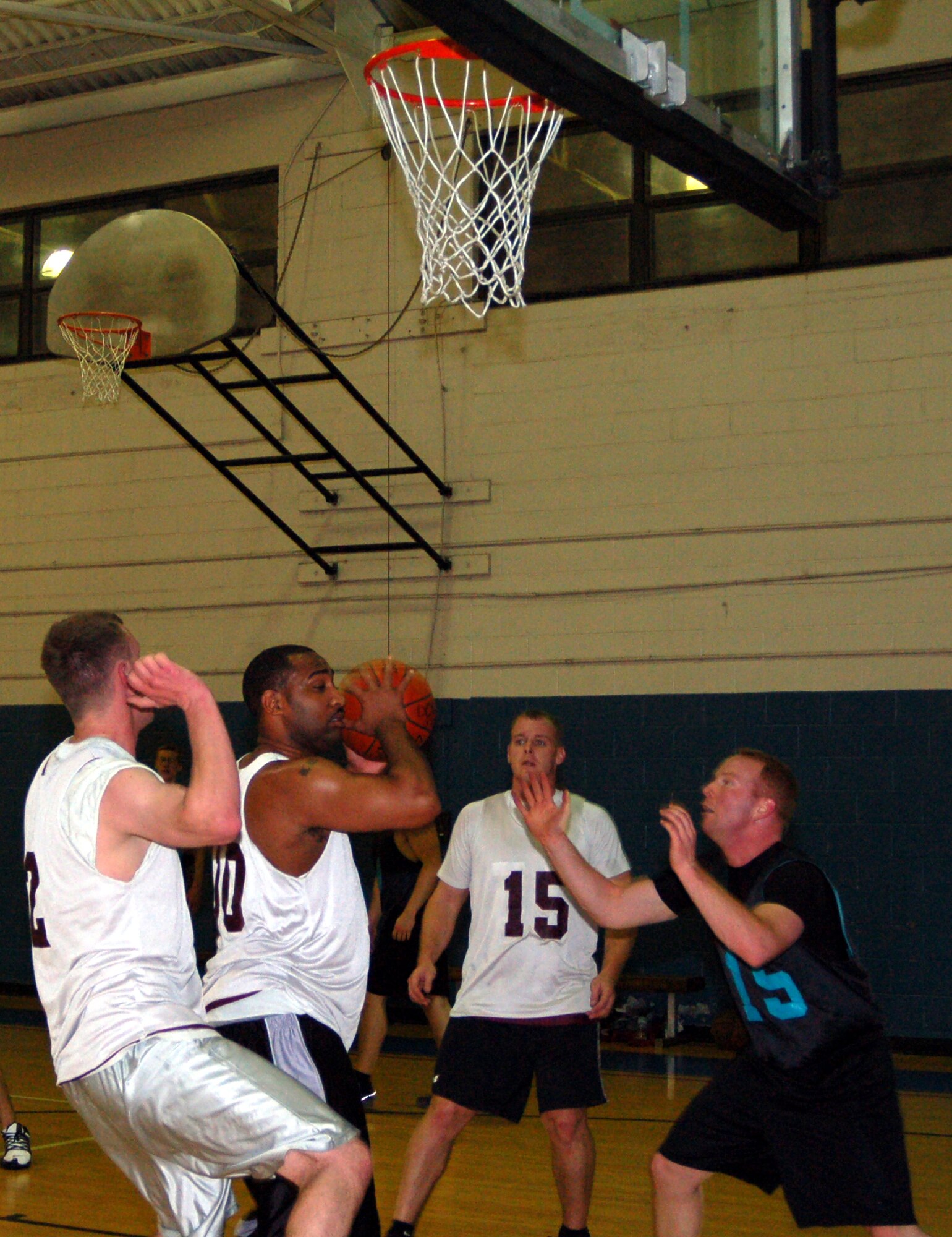 KeAndre Stanton, 436th Communications Squadron, attempts to make a 2-pointer. The 436th CS won the intramural basketball game against the 736th Aircraft Maintenance Squadron 36 – 33 at the Fitness Center Feb. 25. (U.S. Air Force photo/ Airman 1st Class Shen-Chia Chu)