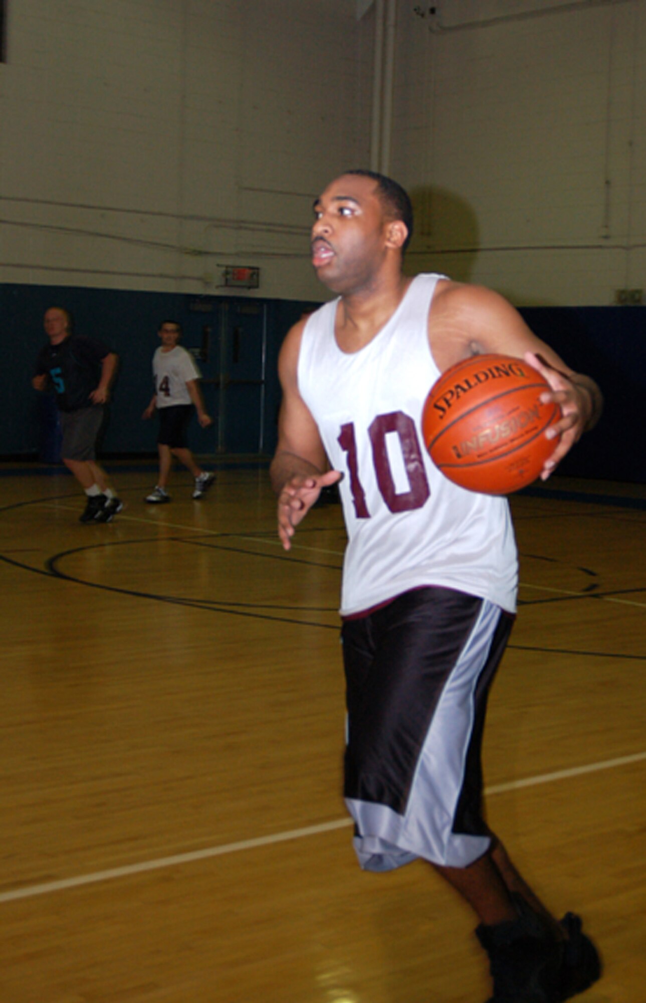 KeAndre Stanton, 436th Communications Squadron, dribbles down the court to make a fast break. The 436th CS won the intramural basketball game against the 736th Aircraft Maintenance Squadron 36 – 33 at the Fitness Center Feb. 25. (U.S. Air Force photo/ Airman 1st Class Shen-Chia Chu)