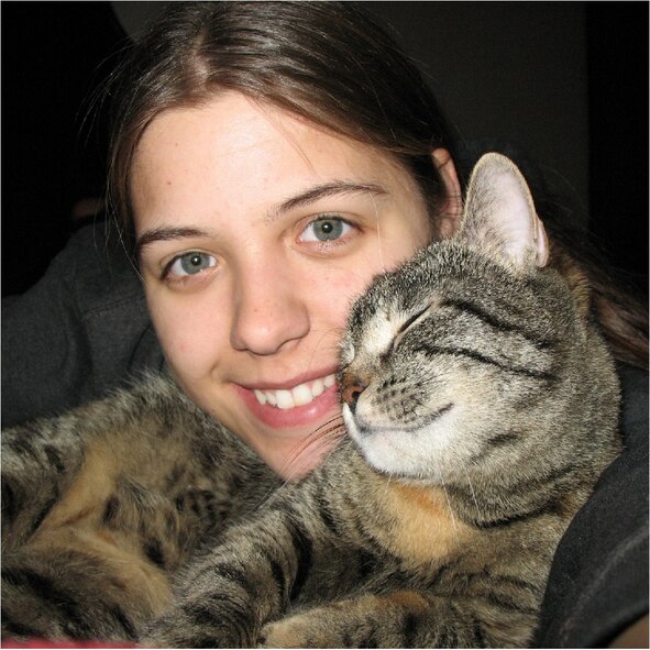 SPANGDAHLEM AIR BASE, Germany -- Jayme Cupples cuddles with Skittles, a cat that has been “lost” since October. Skittles will be reunited with her family here when Tech. Sgt. Errol Gibson make a permanent change of station move from Incirlik AB, Turkey, to Spangdahlem AB, Germany. (Courtesy photo)