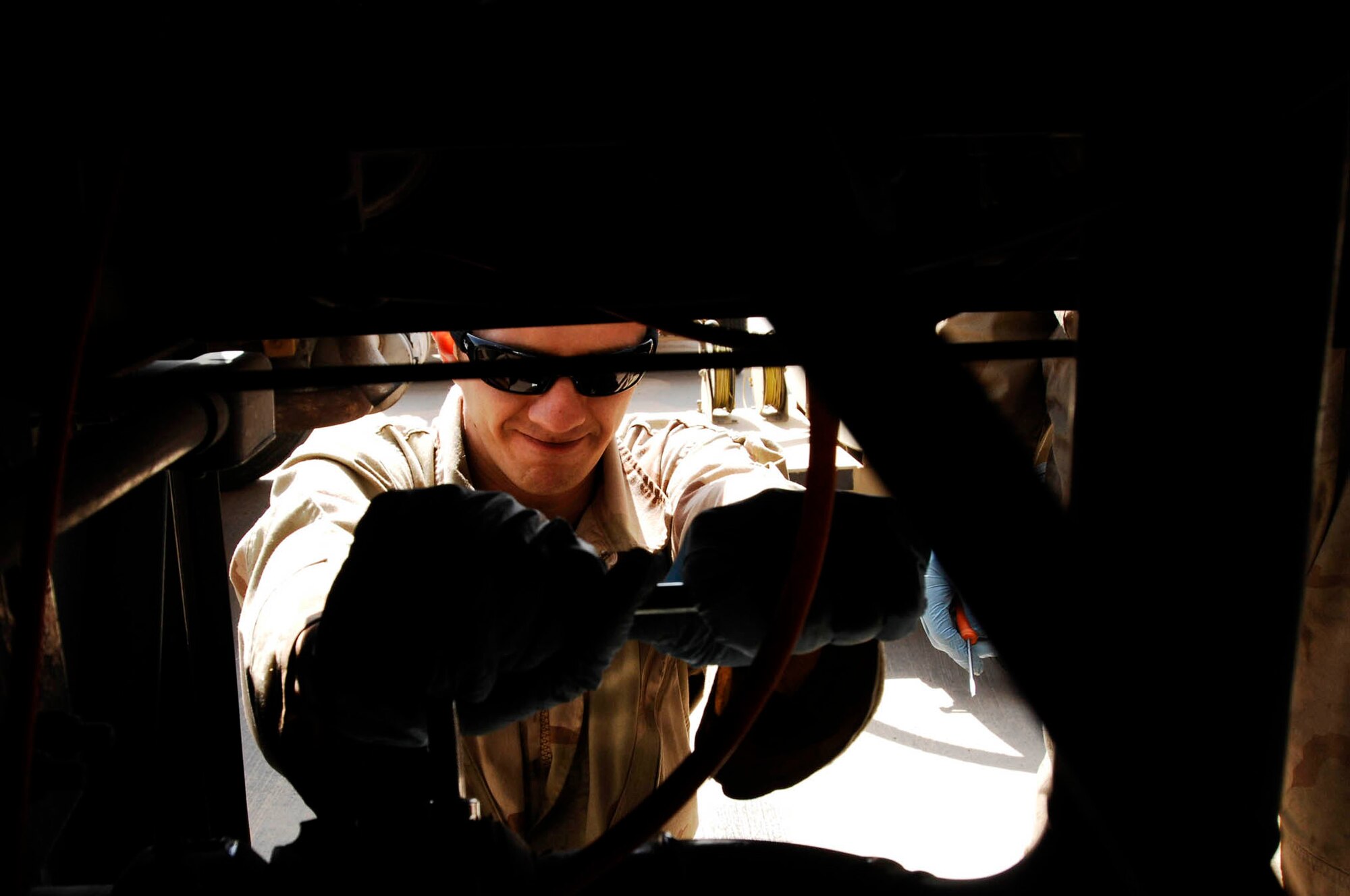 SOUTHWEST ASIA -- Senior Airman Brandon Huelsman, a refueling maintenance technician from the 386th Expeditionary Logistics Readiness Squadron, wrenches loose a bolt in the over wing valve of an R-11 fuel truck for repair at an air base in the Persian Gulf Region Feb. 26, 2008. The fuels management flight is responsible for inventorying the fuel daily, and the transfer and issue of fuel to both vehicle operators and aircrews in support of Operations Enduring and Iraqi Freedom. (U.S. Air Force photo/ Staff Sgt. Patrick Dixon) 