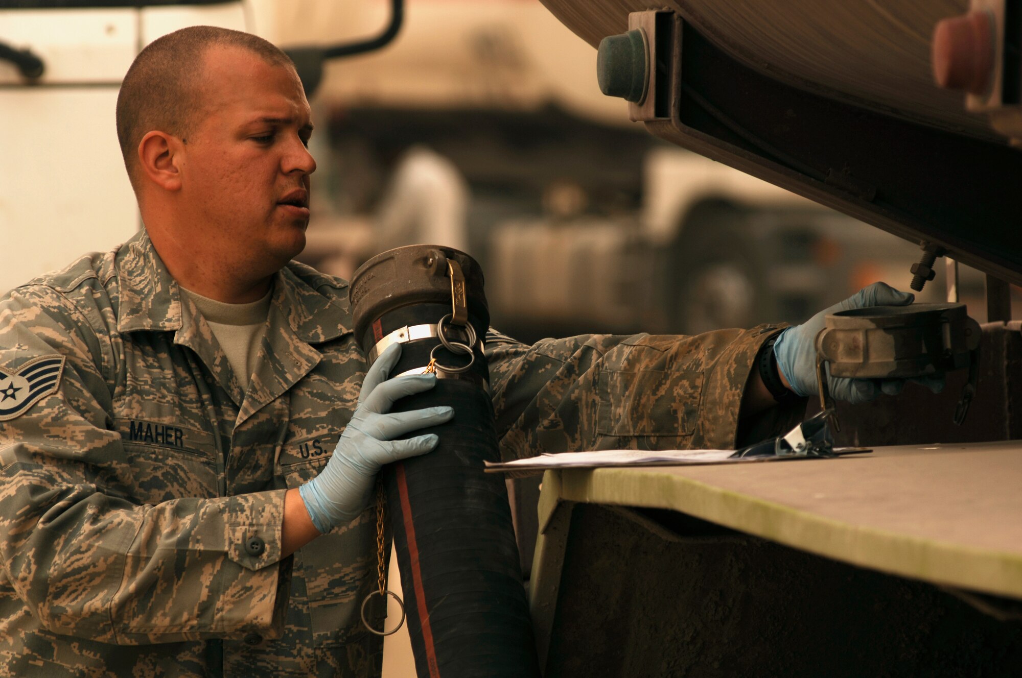 SOUTHWEST ASIA -- Staff Sgt. Kenneth Maher, a fuels technician from the 386th Expeditionary Logistics Readiness Squadron, examines a fuel hose before downloading fuel from a truck into a bladder storage unit at an air base in the Persian Gulf Region Feb. 26, 2008. The fuels management flight is responsible for inventorying the fuel daily, and the transfer and issue of fuel to both vehicle operators and aircrews in support of Operations Enduring and Iraqi Freedom. (U.S. Air Force photo/ Staff Sgt. Patrick Dixon)