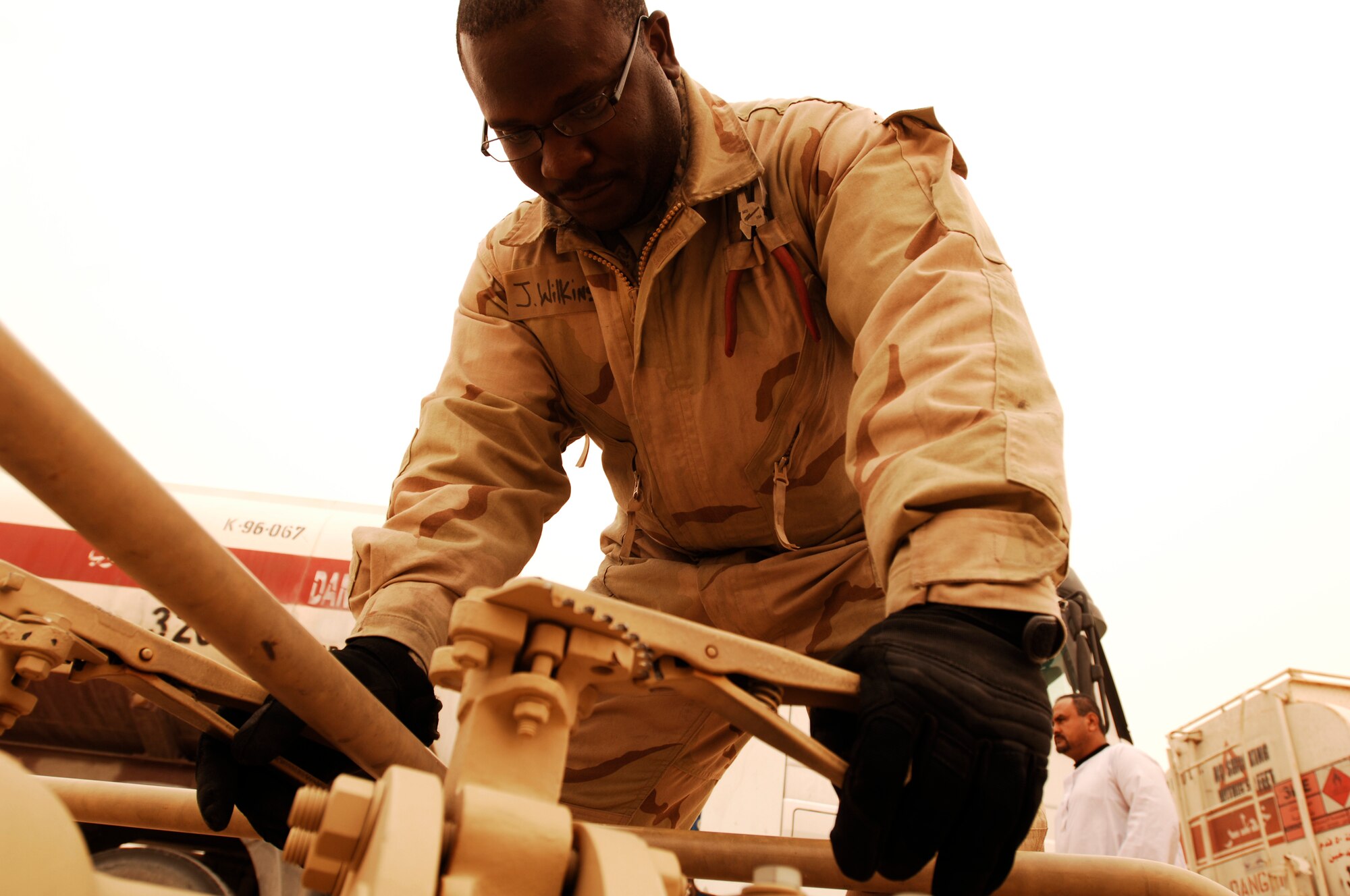 SOUTHWEST ASIA -- Staff Sgt. Jerome Wilkins, a fuels technician from the 386th Expeditionary Logistics Readiness Squadron, watches the sight glass on a receipt wye skid valve to ensure the flow stays constant during the fuel download from trucks into a bladder storage unit at an air base in the Persian Gulf Region Feb. 26, 2008. The fuels management flight is responsible for inventorying the fuel daily, and the transfer and issue of fuel to both vehicle operators and aircrews in support of Operations Enduring and Iraqi Freedom. (U.S. Air Force photo/ Staff Sgt. Patrick Dixon)