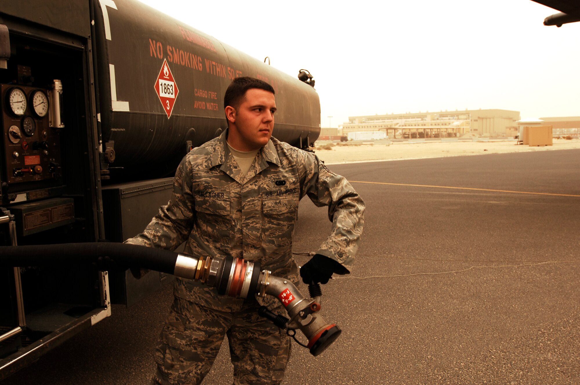 SOUTHWEST ASIA -- Senior Airman Bryan Gallagher, a fuels technician from the 386th Expeditionary Logistics Readiness Squadron, pulls a three-inch hose off an R-11 fuel truck toward a C-130 Hercules needing to be refueled on an air base in the Persian Gulf Region Feb. 26, 2008. The fuels management flight is responsible for inventorying the fuel daily, and the transfer and issue of fuel to both vehicle operators and aircrews in support of Operations Enduring and Iraqi Freedom. (U.S. Air Force photo/ Staff Sgt. Patrick Dixon)