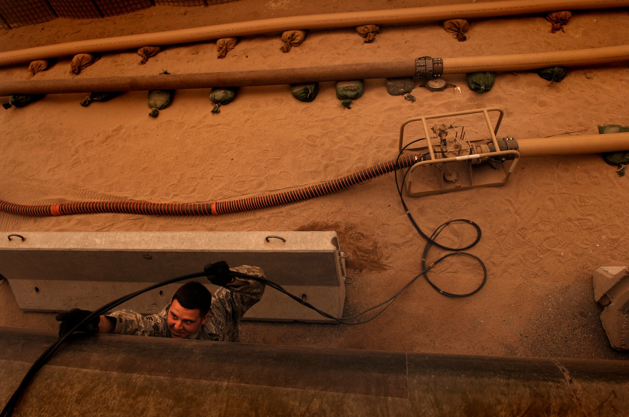 SOUTHWEST ASIA -- Senior Airman Bryan Gallagher, a fuels technician from the 386th Expeditionary Logistics Readiness Squadron, prepares to pump fuel from the ramp bladder storage into an R-11 fuel truck on an air base in the Persian Gulf Region Feb. 26, 2008. The fuels management flight is responsible for inventorying the fuel daily, and the transfer and issue of fuel to both vehicle operators and aircrews in support of Operations Enduring and Iraqi Freedom. (U.S. Air Force photo/ Staff Sgt. Patrick Dixon)
