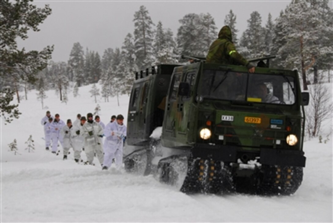 Minnesota National Guardsmen follow along behind a track vehicle as they conduct cold-weather training at Camp Vearnes, Norway, on Feb. 18, 2008.  The Guardsmen are participating in the 35th Annual U.S./Norwegian Troop Reciprocal Exchange which is a two-week winter training and a cultural exchange.  