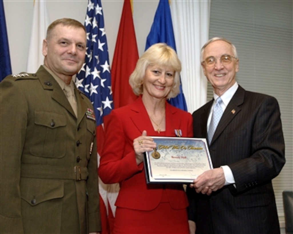 Deputy Secretary of Defense Gordon England (right) presents the certificate for the Secretary of Defense Medal for the Global War on Terrorism to Beverly Hall of the Defense Language Institute during Pentagon ceremonies on Feb. 26, 2008.  Fourteen medals were presented to Department of Defense civilians who served abroad in direct support of military operations to combat terrorism.  Vice Chairman of the Joint Chiefs of Staff Gen. James E. Cartwright (left), U.S. Marine Corps, joined England for the ceremony.  