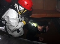 Lance Cpl. Mark Baker, an extractor from Company B, Chemical Biological Incident Response Force, II Marine Expeditionary Force, prepares to extract a simulated casualty, Josh Dale, during a training exercise Feb. 28 at the Washington Metropolitan Area Transit Authority in Landover, Md.