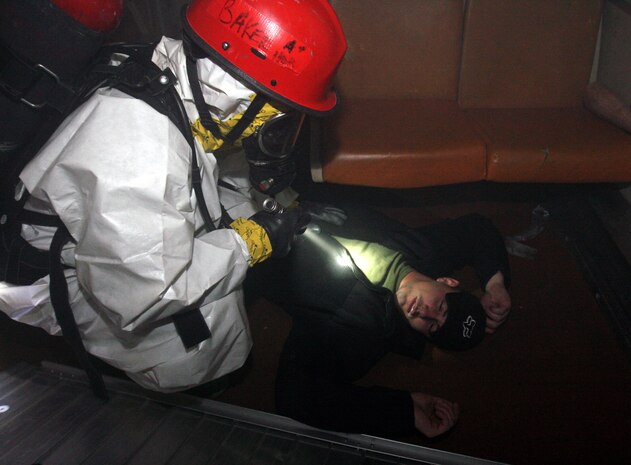 Lance Cpl. Mark Baker, an extractor from Company B, Chemical Biological Incident Response Force, II Marine Expeditionary Force, prepares to extract a simulated casualty, Josh Dale, during a training exercise Feb. 28 at the Washington Metropolitan Area Transit Authority in Landover, Md.