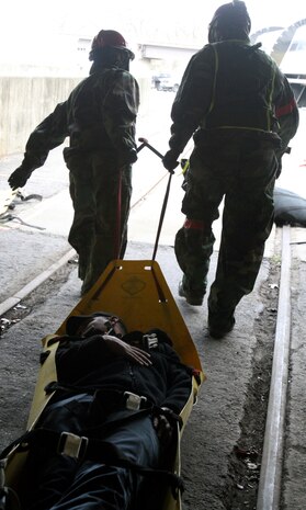 Two Marines from Company B, Chemical Biological Incident Response Force, II Marine Expeditionary Force, extract a simulated casualty, Josh Dale, from a simulated chemical, biological, radiological, nuclear, high-yield explosion incident, during a training exercise Feb. 28 at the Washington Metropolitan Area Transit Authority in Landover, Md. Dale was given anti-acid tablets to make him foam at the mouth, which simulated being infected with Phosgene, a poisonous gas. Dale will process through the decontamination line before going to the medical stability tent for follow-on medical care.