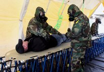 Cpl. James Elwell (left) and Cpl. Shawn Megill (right) decontamination platoon members, Company B, Chemical Biological Incident Response Force, II Marine Expeditionary Force, help decontaminate a simulated casualty, Josh Dale, who was extracted from a simulated chemical, biological, radiological, nuclear, high-yield explosion incident, Feb. 28, during a training exercise at the Washington Metropolitan Area Transit Authority in Landover, Md. After being processed through the decontamination line, Dale will be transported to the medical stability tent for follow-on medical care.