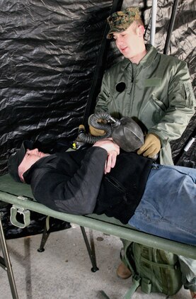 Navy Petty Officer 3rd Class Matthew Esper, a hospital corpsman with Headquarters and Service Company, Chemical Biological Incident Response Force, II Marine Expeditionary Force, provides follow-on care for simulated casualty Josh Dale during a training exercise Feb. 28 at the Washington Metropolitan Area Transit Authority in Landover, Md. Marines and sailors honed their skills on decontamination techniques, emergency lifesaving skills and extraction techniques.
