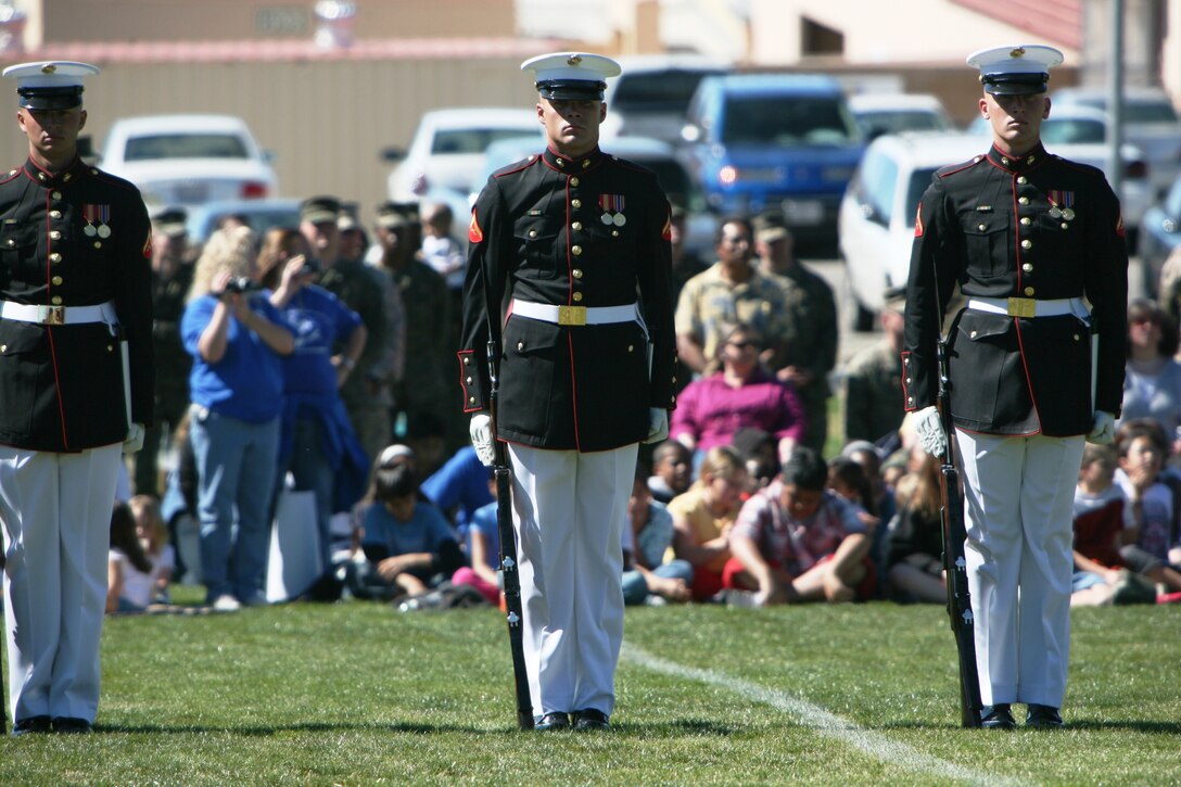 Marines from the Silent Drill Platoon stand at position of attention after rifle inspection during the Battle Color Ceremony aboard the Combat Center at Lance Cpl. Torrey L. Gray Field Feb. 29. The 24 highly-trained Marines making up the Silent Drill Platoon harmonized their drill sequences, tossing and spinning rifles in close proximity of each other. The Silent Drill Platoon has become famous across the world due to their precise synchronized performances.