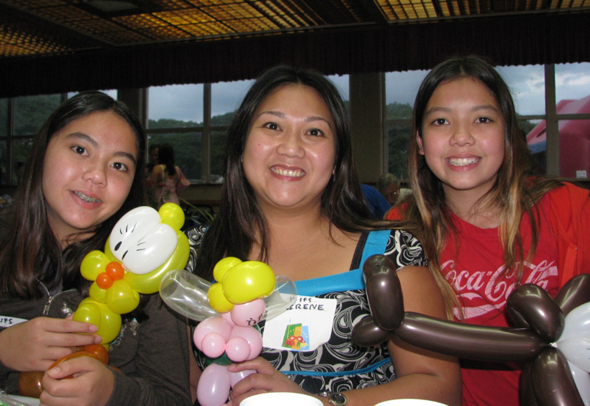 A family of TSgt Nathan Nash, 15th Security Forces, from left, Brittany (daughter), Irene (wife), and Kendra (daughter) posed at the monthly activity dinner at Nelles Chapel.


