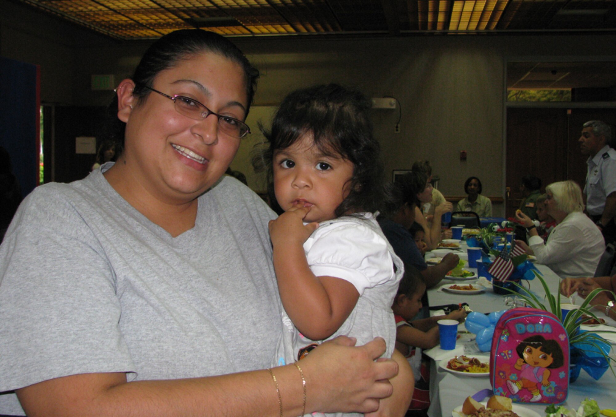 Else, wife of A1C Gabriel  Solis (15 Security Forces) and daughter, Adriana, posed during the monthly activity dinner at Nelles Chapel.
