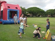 Enjoys the game during the monthly activity dinner at Hickam Nelles Chapel. 