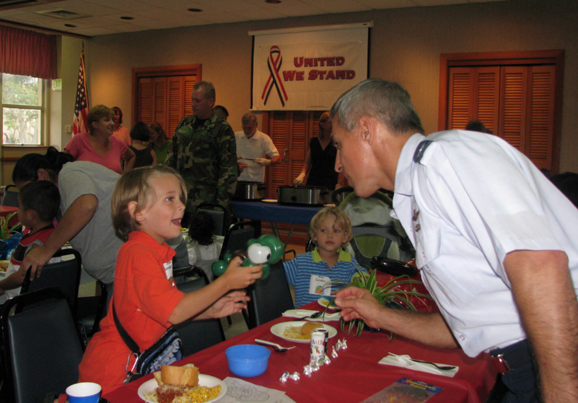 Col J.J. Torres, 15 AW Commander, interacts with Connor (15 AW/JA, Capt Colaw’s son) at the monthly activity dinner at Nelles Chapel.  