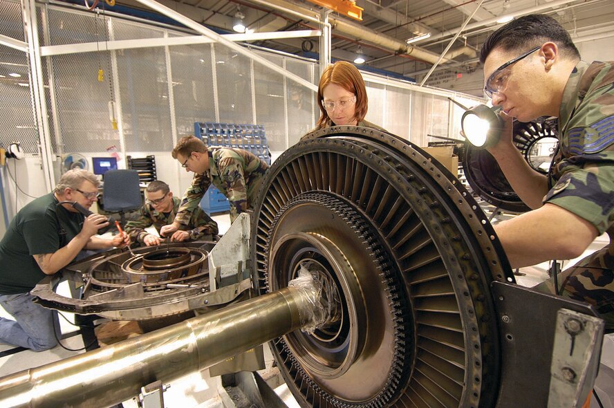 Mechanics work on an F101 low pressure turbine module in the F101 Jet Engine Intermediate Maintenance Shop of the 545th Propulsion Maintenance Squadron at Tinker Air Force Base, Okla. Pictured from left to right are: Louis Comstock, Master Sgt. Richard Palmer, Staff Sgt. Justin Goode, Tech. Sgt. Kristin Coates and Tech. Sgt. Brannon Tackett. (Air Force photo by Margo Wright)
