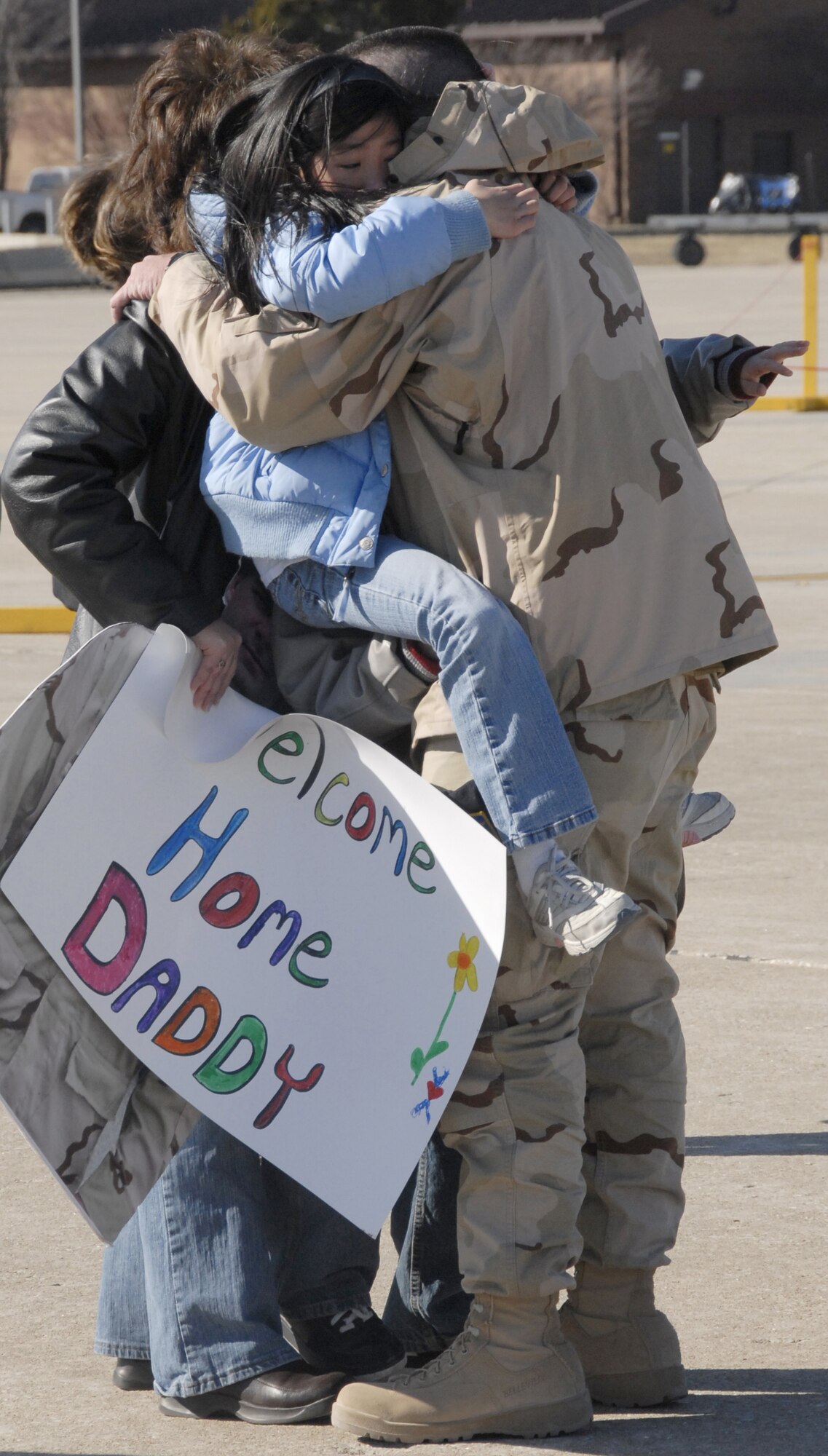 Staff Sgt. Derik Campbell embraces family members at Whiteman Air Force Base, Mo., after returning from a six-month deployment to Iraq.  Sergeant Campbell, an Air Force reservist in the 442nd Security Forces Squadron, returned home Feb. 29, 2008, along with approximately 30 other squadron members and Citizen Airmen from the 442nd Logistics Readiness Squadron.  The reservists were greeted by senior leaders from the 442nd Fighter Wing and, more importantly, family members and friends.  Security forces reservists provided air-base ground defense at Kirkuk Air Base, Iraq, while LRS members supported convoy operations. (U.S. Air Force photo/Maj. David Kurle) 